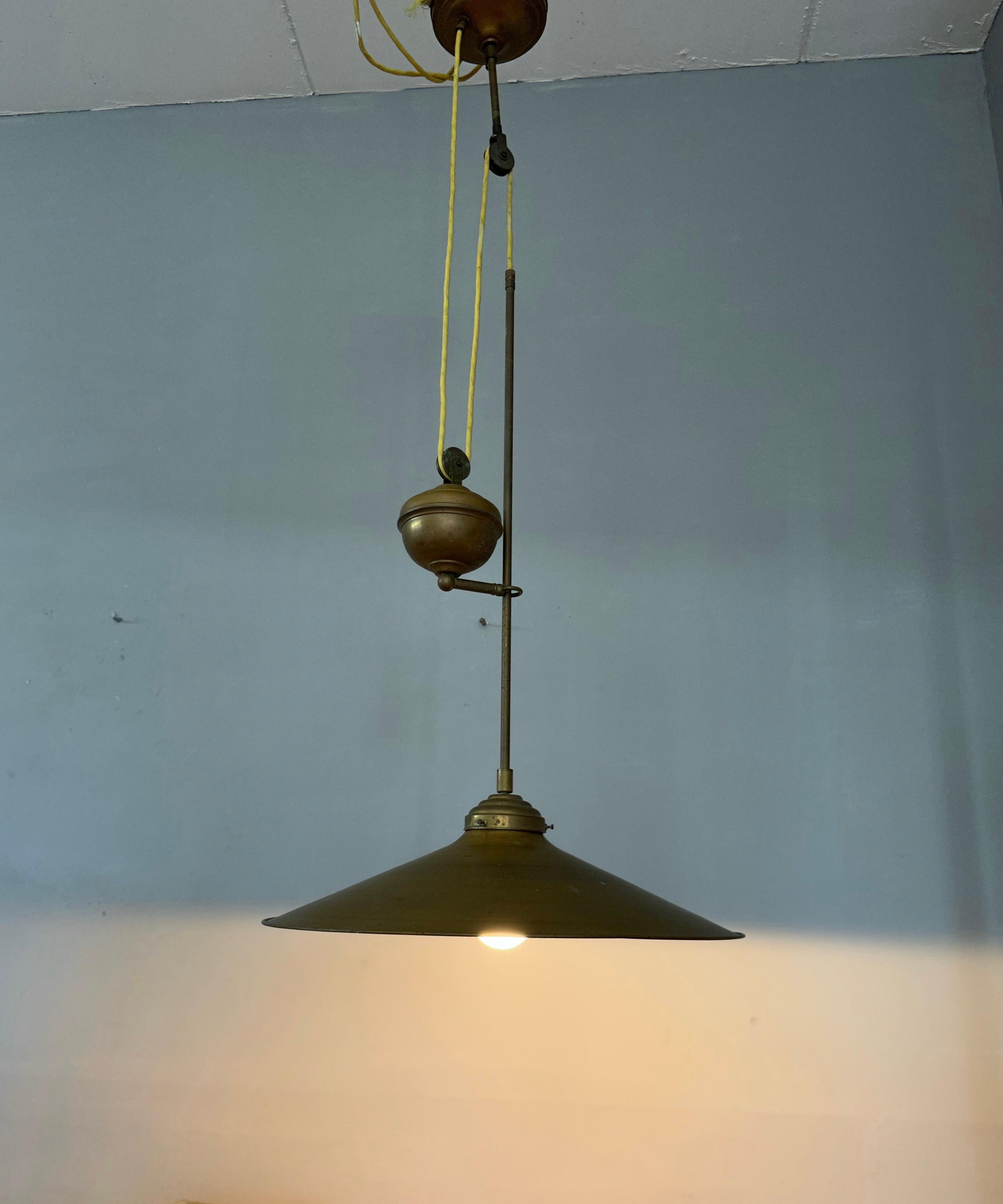 Stylish, midcentury made and height adjustable light fixture with a great patina.

This rare 1970s light fixture is ideal for bringing good style and the perfect kind of light to your midcentury kitchen, dining area, living room, landing etc. This