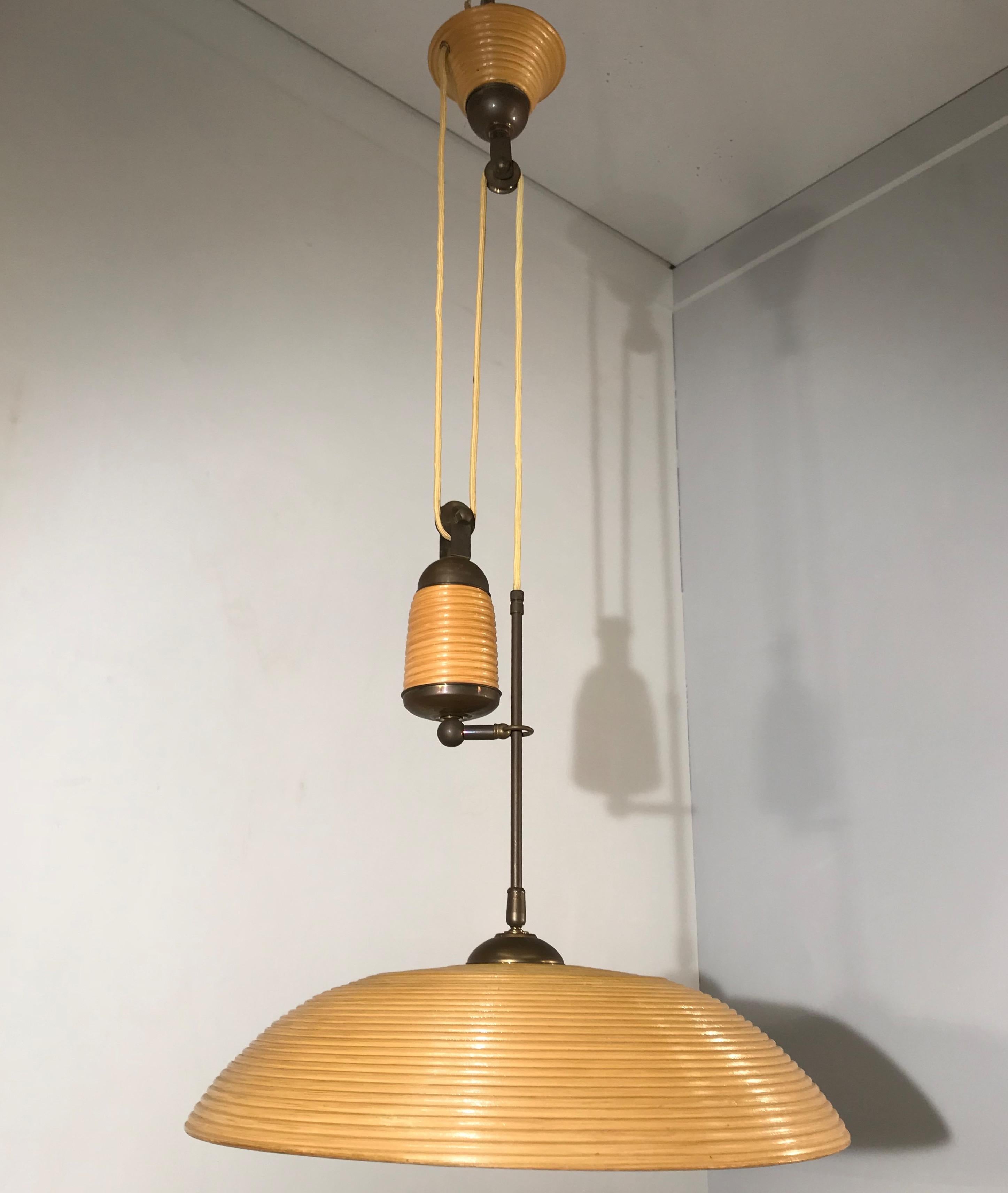Stylish midcentury ceiling lamp.

This rare 1970s light fixture is perfect for bringing good style and the perfect light to your midcentury kitchen, hallway, living room, landing etc. This pendant comes with a beautifully shaped, rattan shade with