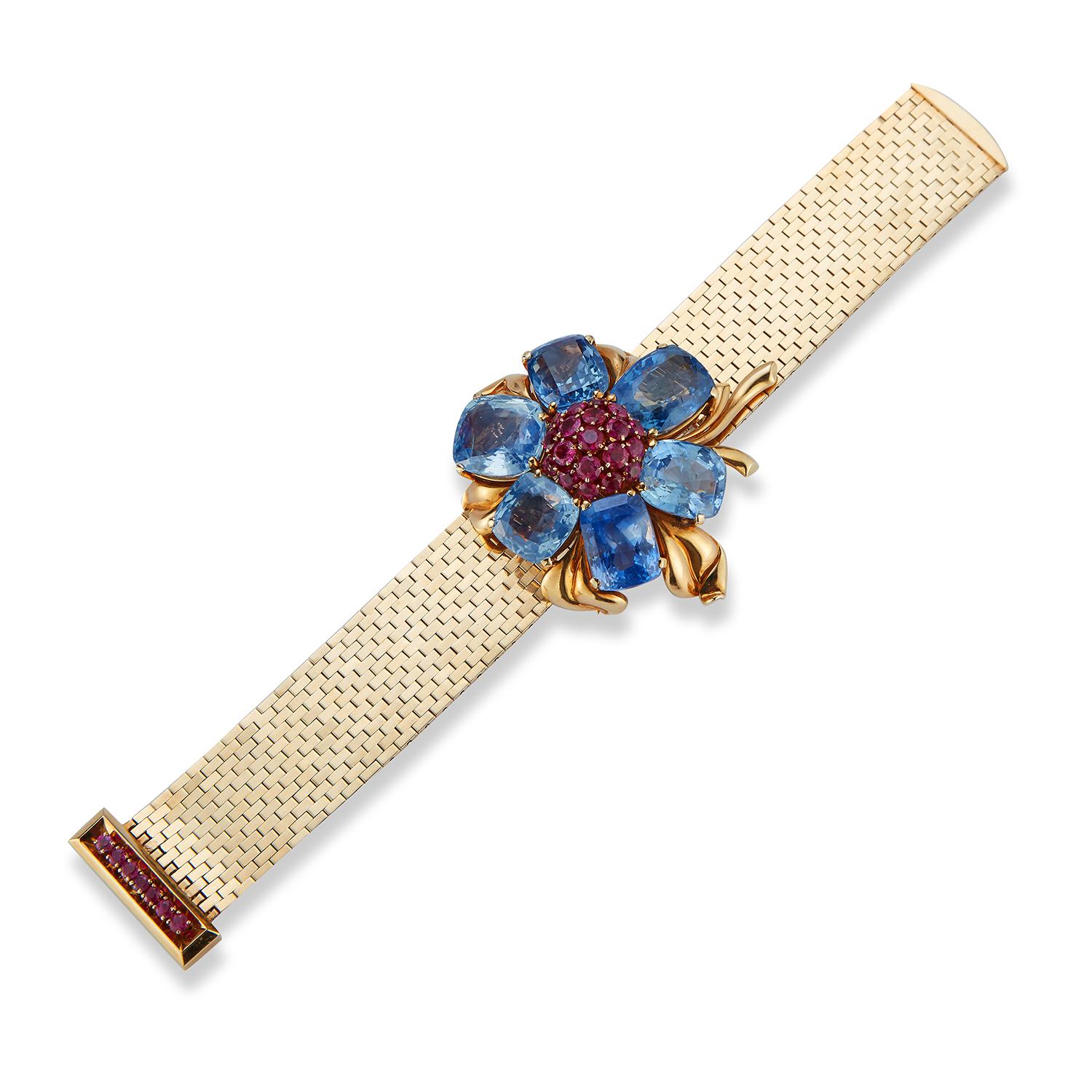 Rare and Iconic Van Cleef & Arpels Passe Partout Sapphire & Ruby Bracelet , 
With a removable  flower brooch. This bracelet can be worn with or without the brooch. 
Six cushion cut sapphires surrounding round cut rubies all set in 18k yellow gold 
