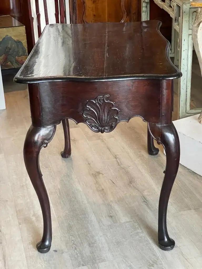 Rare and important 18th century Portuguese console made of Brazilian Rosewood. The eared serpentine top above a shaped frieze fitted with two drawers on cabriole legs with scrolling feet. Having exceptional original silver-plated pulls H:34.50