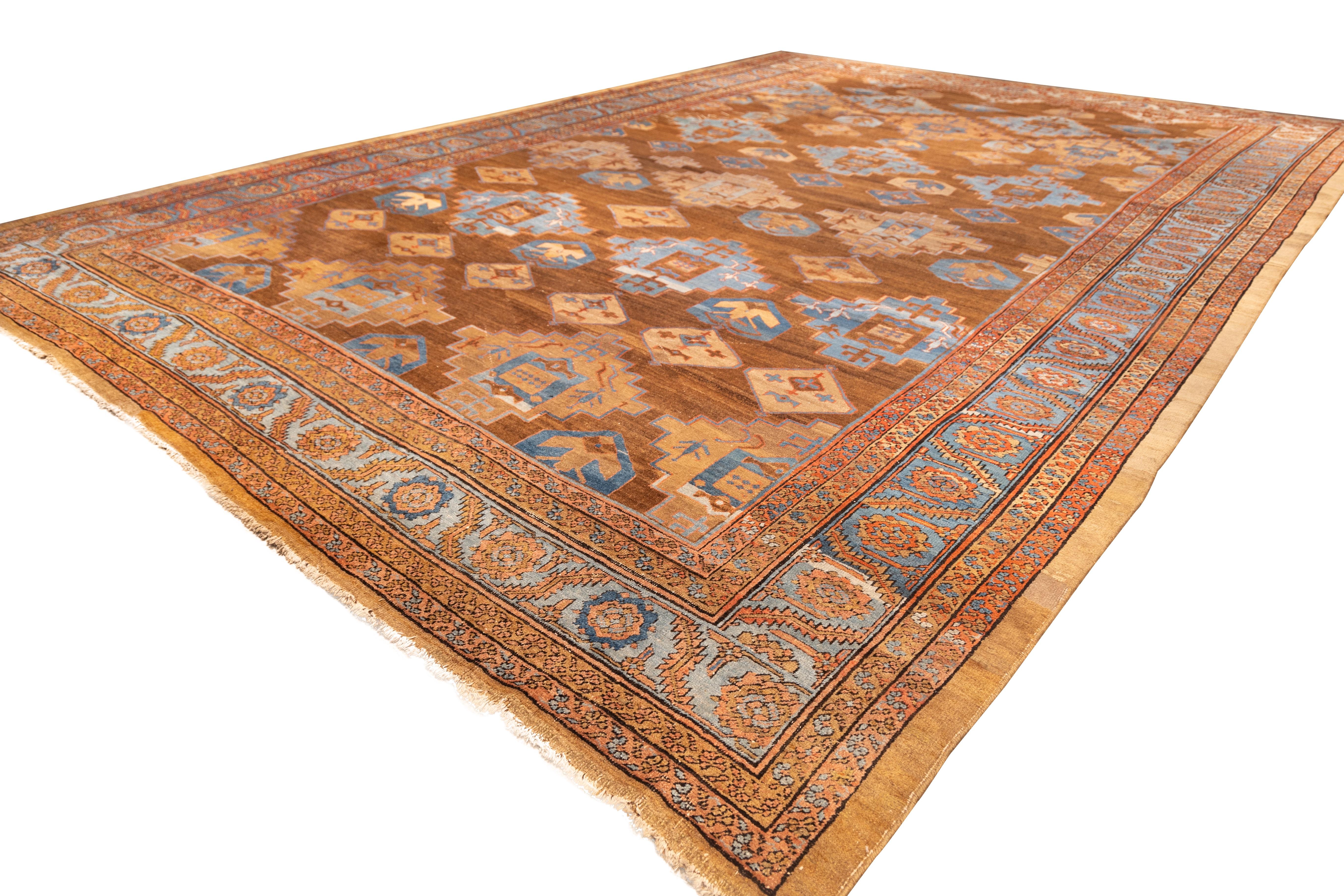 Rare Bakhshayesh camelhair carpet from the 19th with bold tribal geometry and subdued, organic color. The field—woven in lustrous, undyed camelhair—displays a striking lattice of stepped medallions and diamond motifs, rendered in sky blue, brick