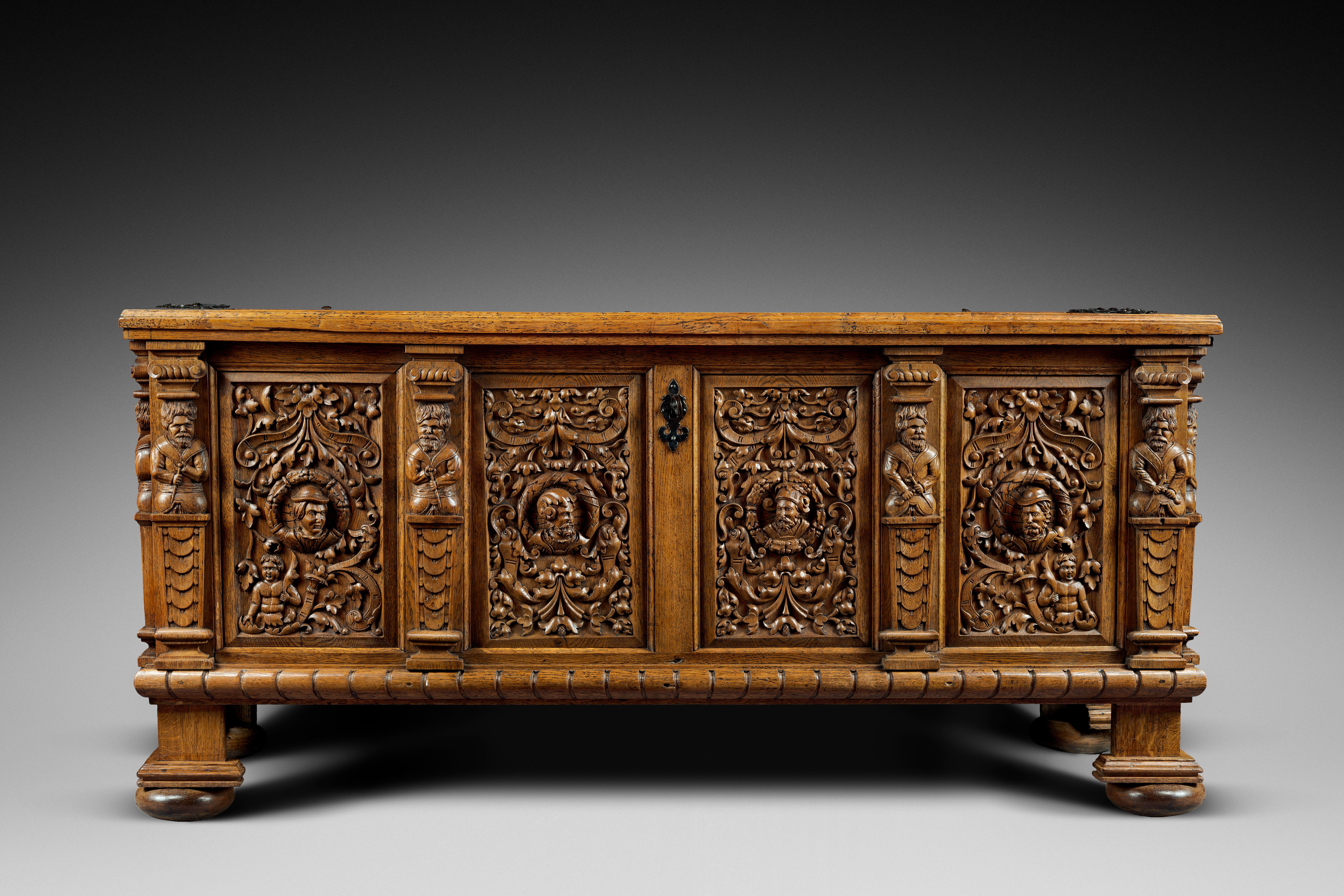 Oakwood
Original lock and key
 
This beautiful and robust chest stands on square feet ending in flattened buns. The base presents plain mouldings. The facade is divided in four panels and four sheathed male terms. Each panel figures a medallion