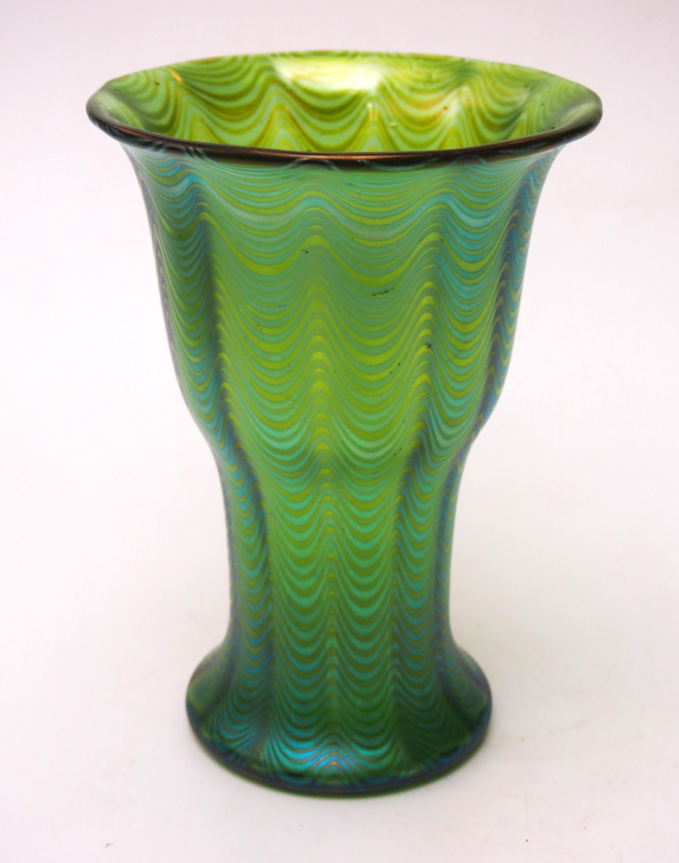A stunning and fully documented Loetz Phaenomen Vase. This example is documented Phaenomen pattern PG 6893 and the colouring is called Crete (green) - The pattern PG 6893  has threads that are drawn into a wave pattern in a mould (often a 16 part