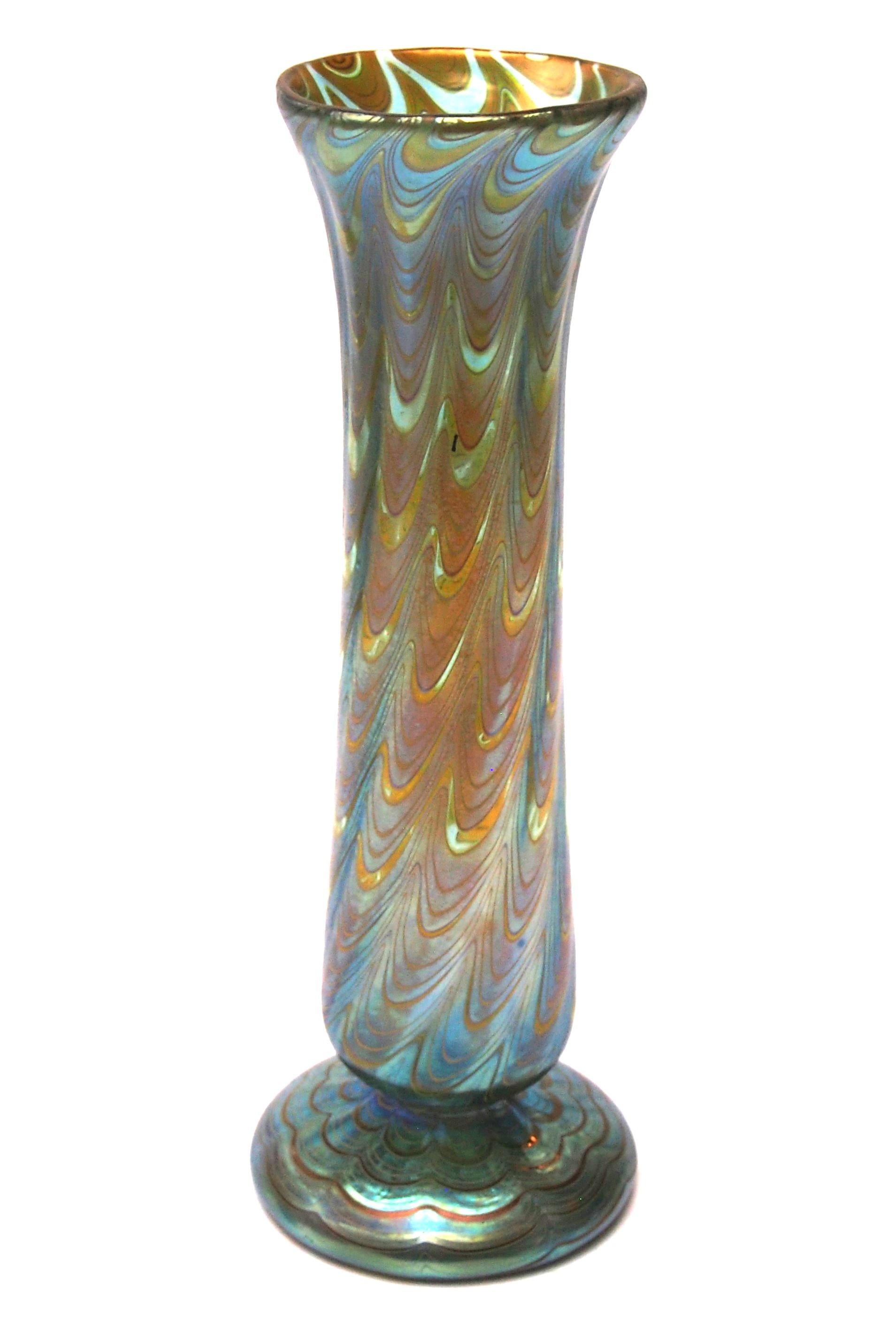 A stunning and fully documented Loetz Phaenomen Vase. This example is documented Phaenomen pattern PG 6893 and the colouring is called Mountain blue (green over a blue ground) - The pattern PG 6893  has threads that are drawn into a wave pattern in