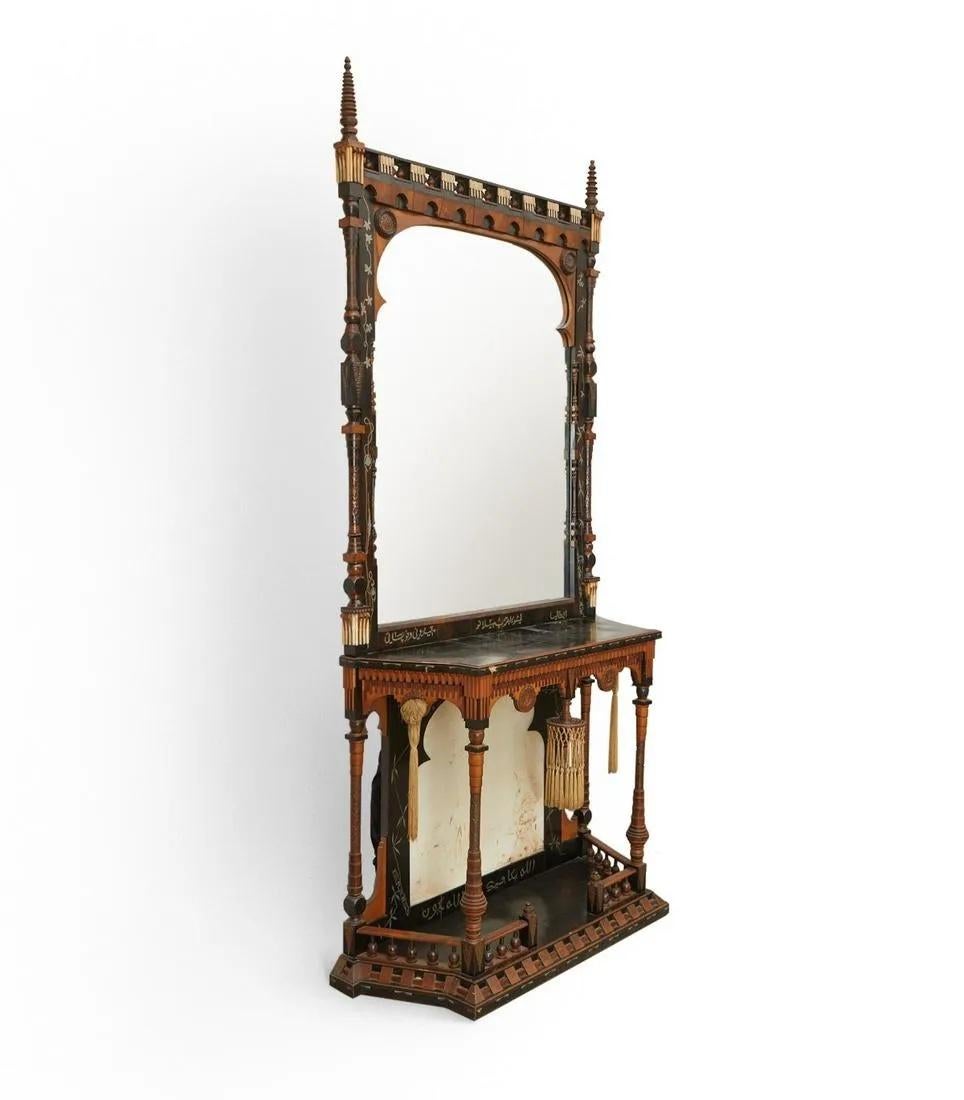 Rare and important Orientalist console table and mirror by Carlo Bugatti (Italian,1856-1940). 
This elegant Moorish design is made of intricately carved and ebonized walnut inlaid with pewter, bone and copper, partially covered with parchment. The