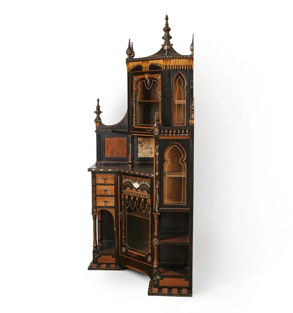 Important et rare cabinet de Carlo Bugatti, (1856-1940) . Ce meuble exceptionnel de conception asymétrique est fait de noyer finement sculpté et ébénisé, incrusté d'étain, d'os et de cuivre, partiellement recouvert de parchemin. La section centrale