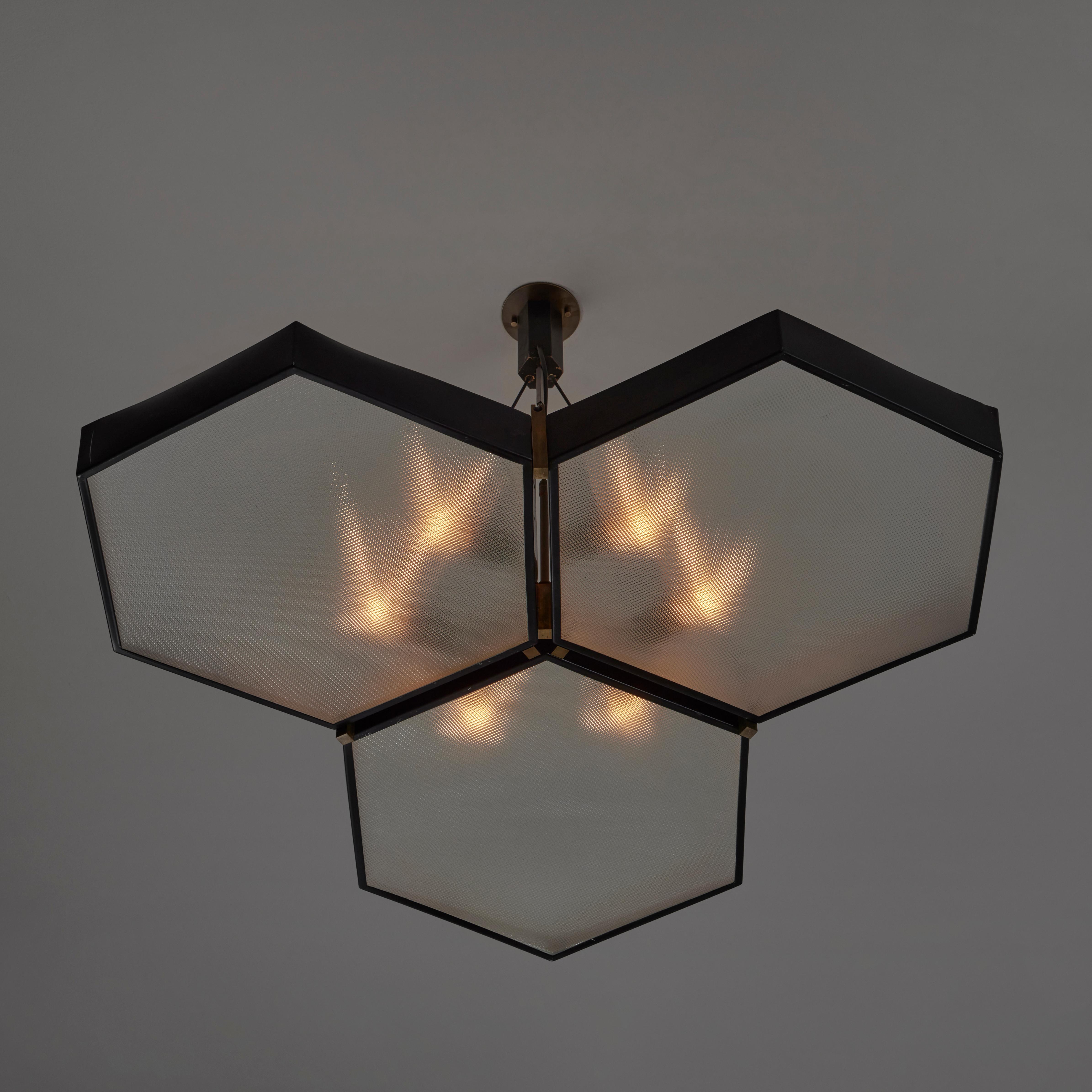 Rare and Large Chandelier by G.C.M.E. Designed and manufactured in Italy, circa 1960. Geometric chandelier with enameled steel frame and three hexagonal textured glass shades. Please note there are minor connection areas from glass to frame that are
