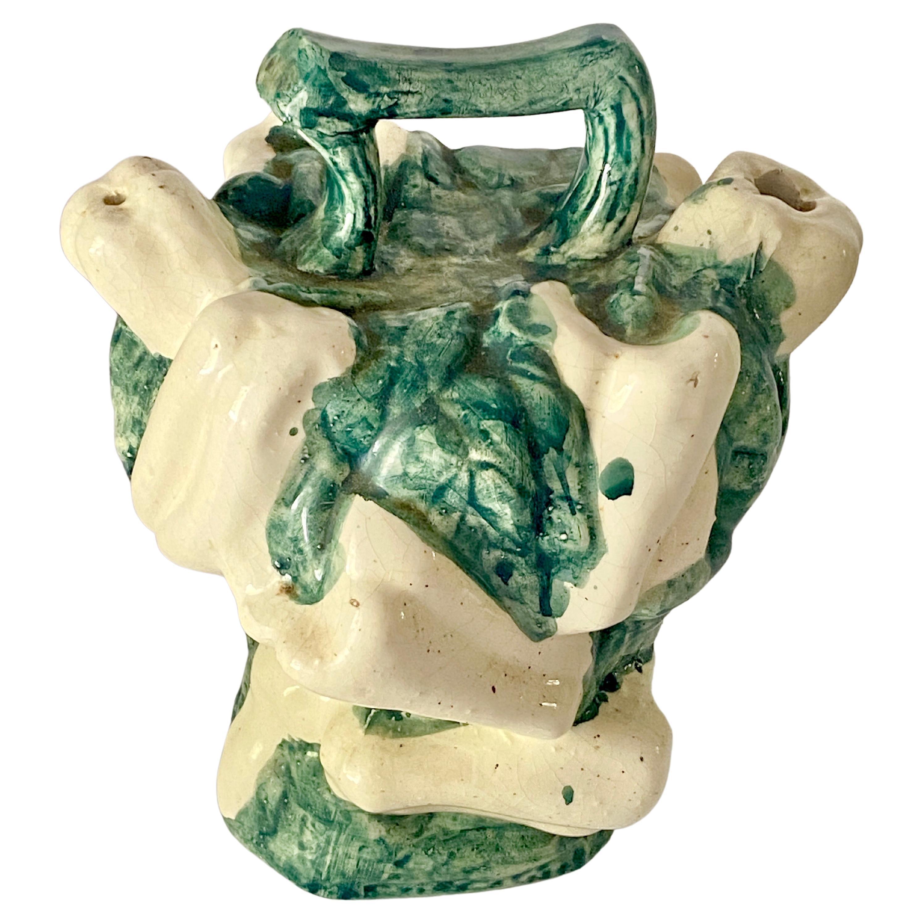 Thus Jug is a very rare model. It is large, and it's free form is totally unusual. You but the watter through one hole of the majolica pitcher And the water will flow through the other hole of the jug, to serve water or whatever.
It has been made
