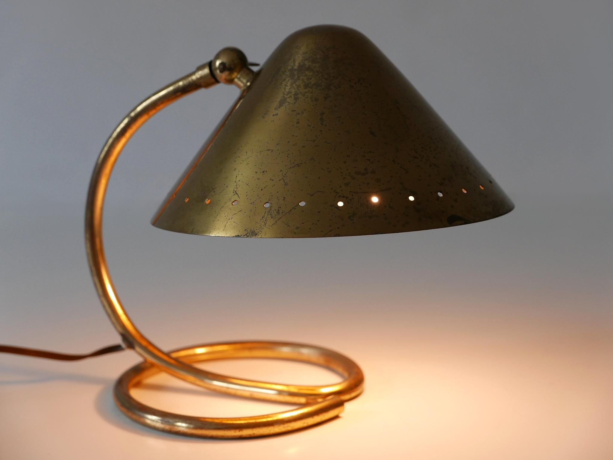 Small and elegant Mid-Century Modern table lamp with adjustable shade. It can be used as wall light as well. Designed and manufactured probably in Sweden, 1950s.

Executed in brass sheet and tube, the lamp comes with 1 x E14 / E12 Edison screw fit