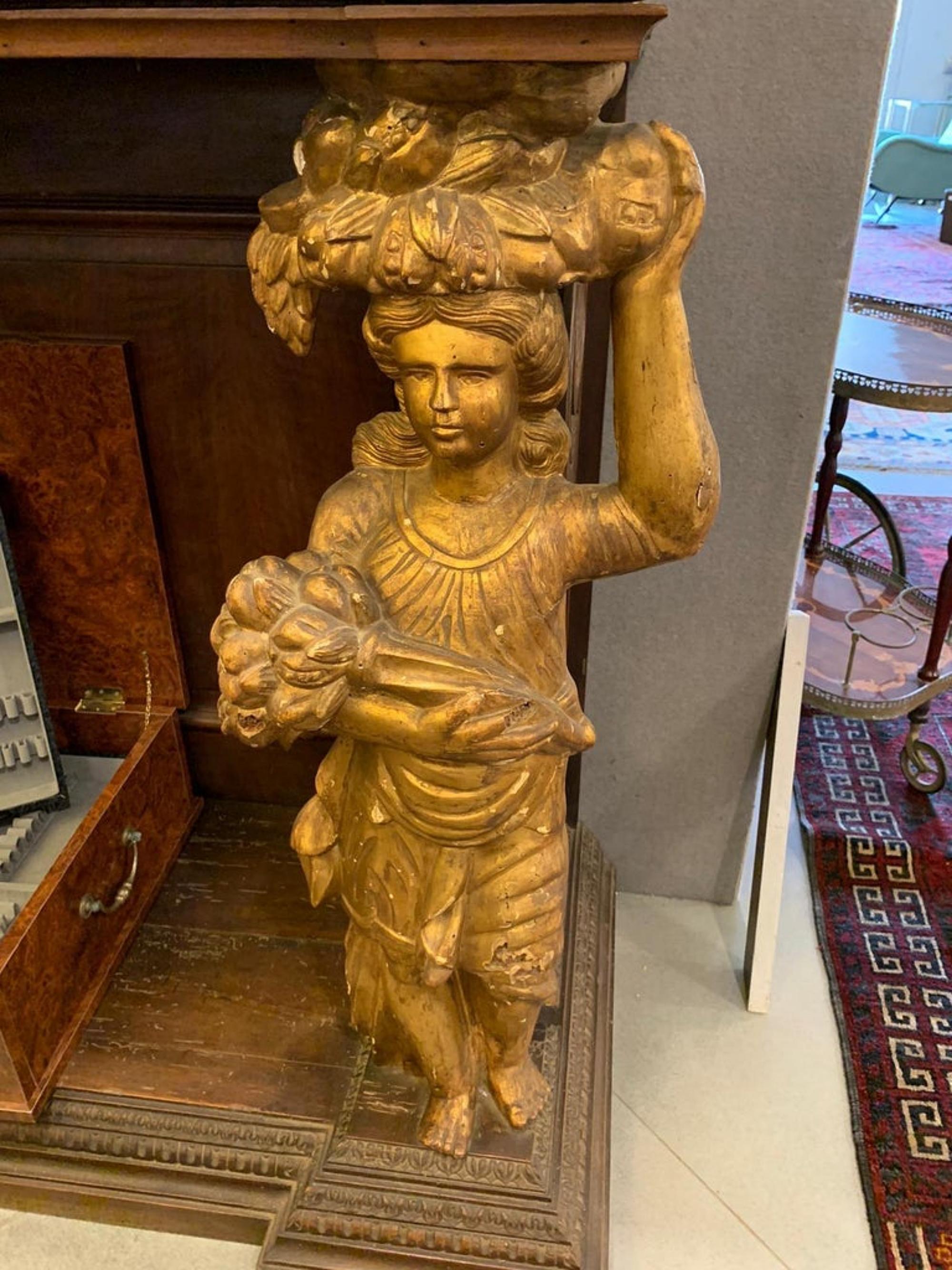 19th Century SICILIAN CABINETWORKING Double body cabinet
Italy  - Sicily
Double-body Renaissance piece of furniture in walnut wood, richly carved with golden caryatids at the base and putto in the upper body and two pine cones in gilded wood.

173 x