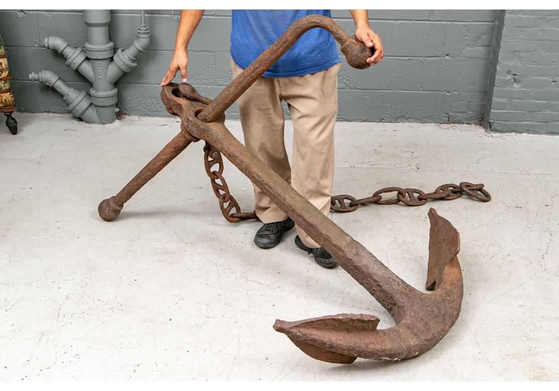 An authentic Maritime ship’s anchor with a section of very large link double whole chain. In all original as found condition and having a really appealing all-over age/use patina. Very large with a weight estimate of 300-400 pounds. Iron with