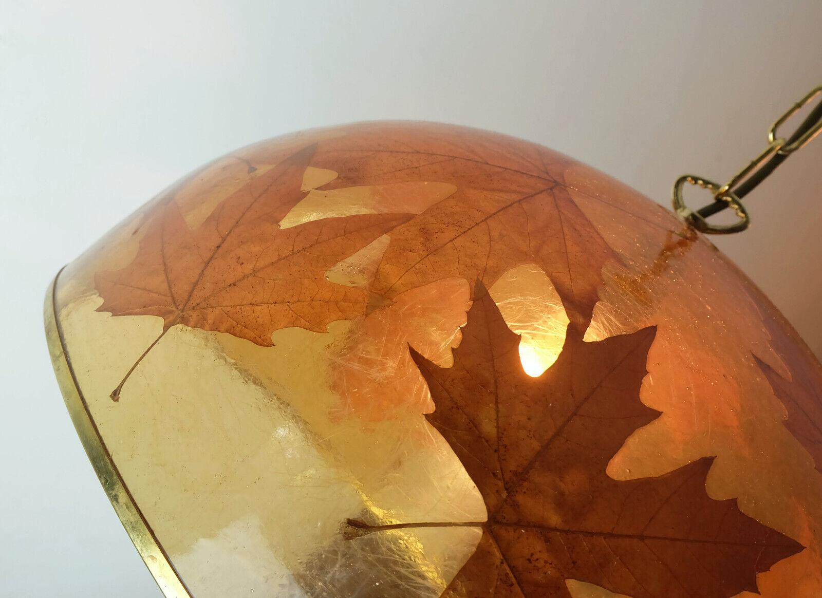 A very rare and outstanding 1970s pendant light made of light amber color resin and real maple leaves. The rim, chain and canopy are made of brass. Origin most probably Italy. For 1 bulb with E27 socket. 

Dimensions in cm:
Length 102 cm, diameter