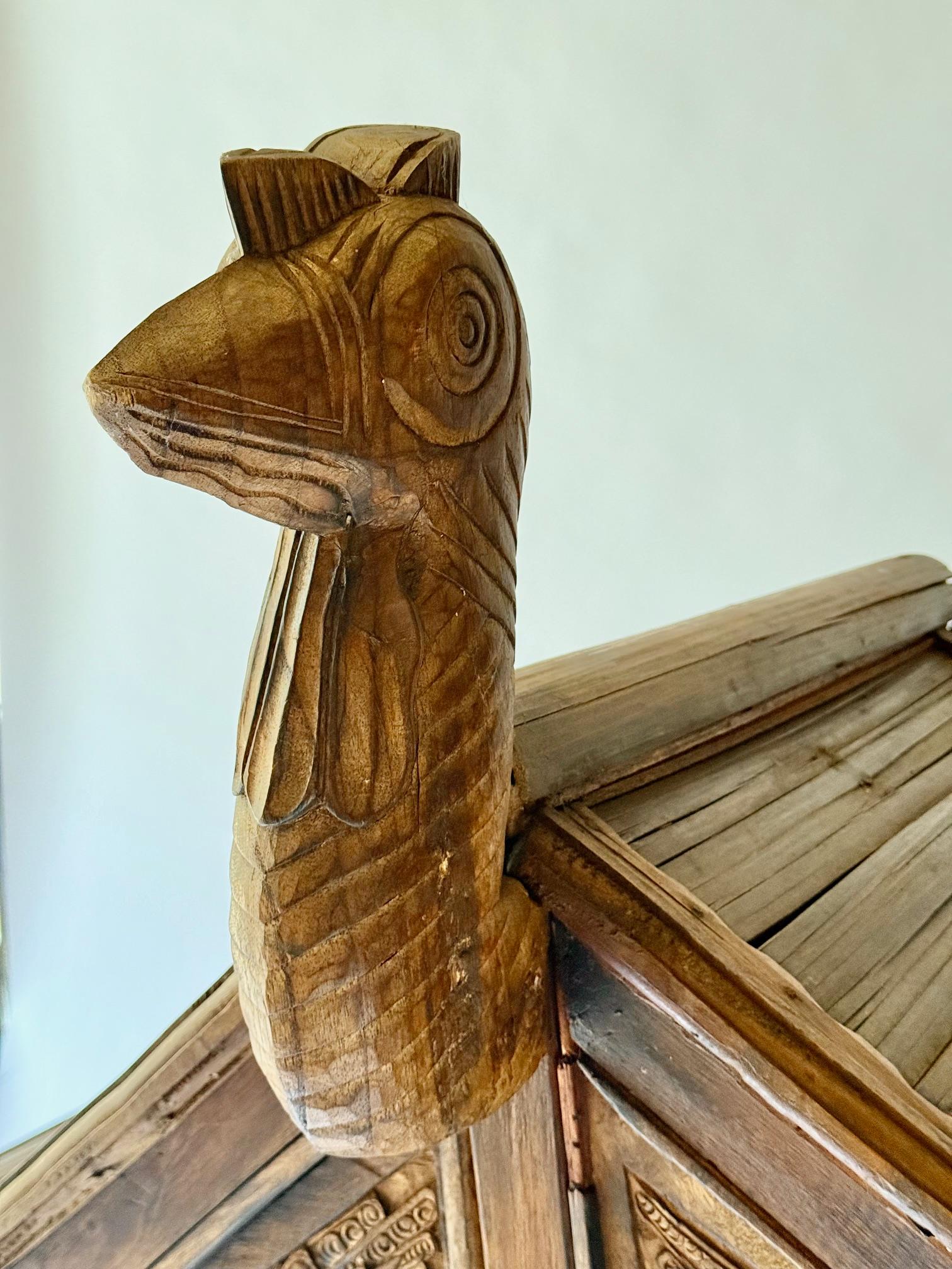 Rare and primitive Sumatran Two Drawer Bird Cabinet.  Bird Carvings on all Four Sides.  Teak and Bamboo.  1900.  Indonesian.
