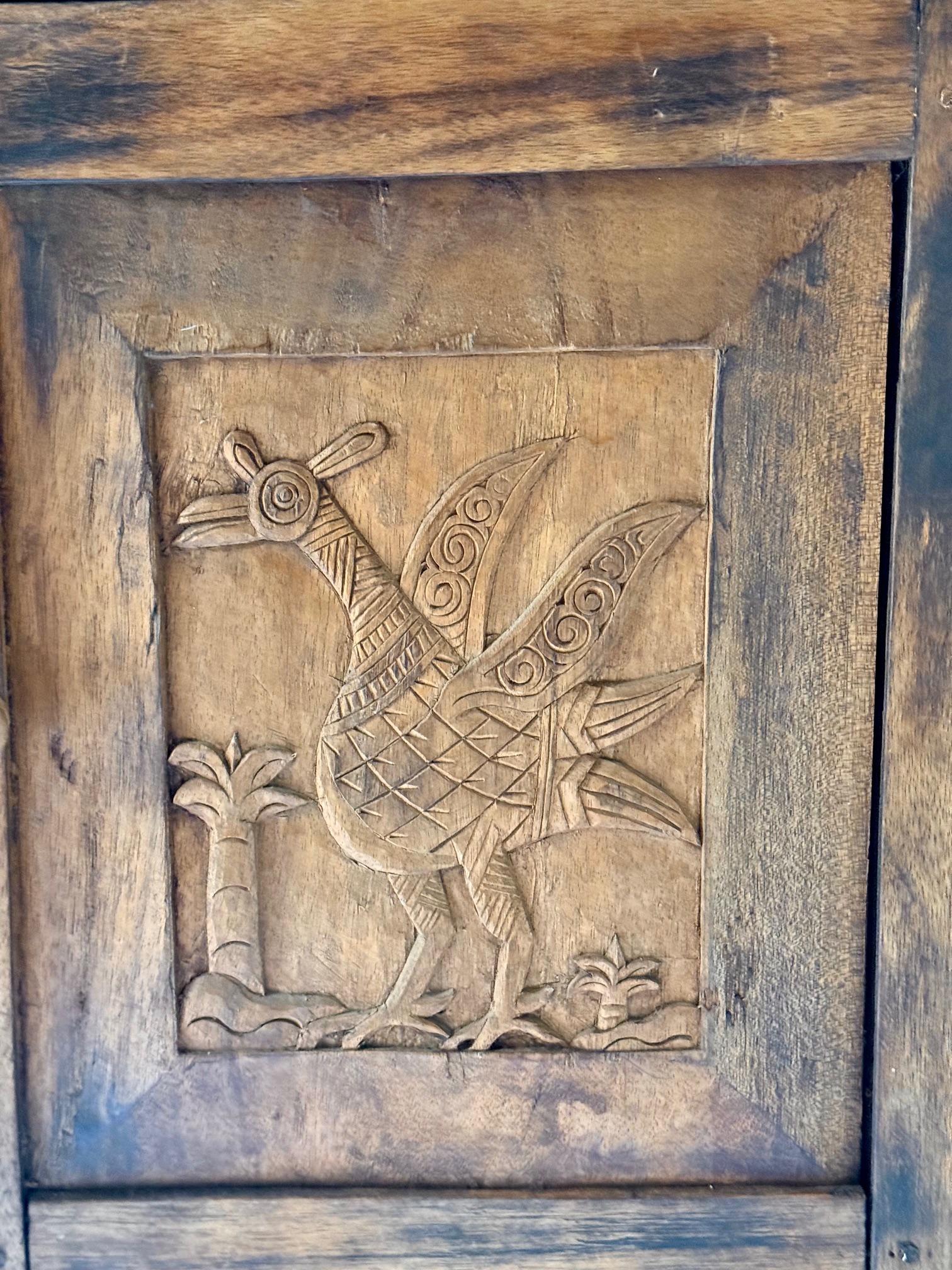 Carved Rare and primitive Sumatran 2 Drawer Cabinet with Bird Carvings on all 4 Sides. For Sale