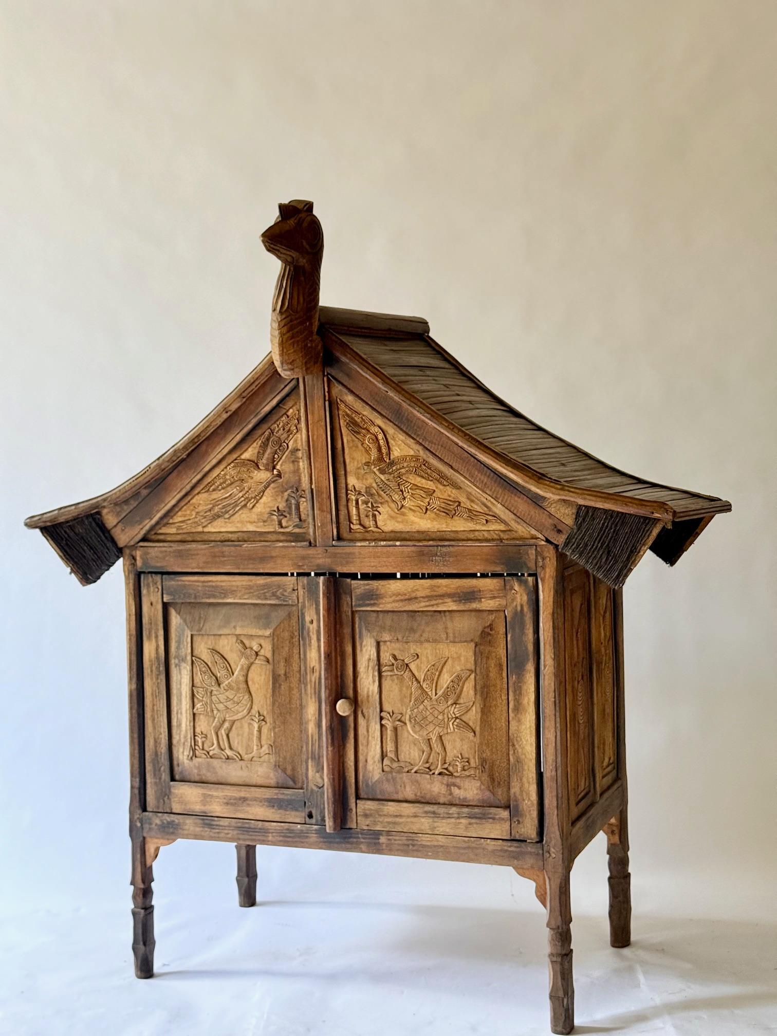 Rare and primitive Sumatran 2 Drawer Cabinet with Bird Carvings on all 4 Sides. In Good Condition For Sale In Sag Harbor, NY