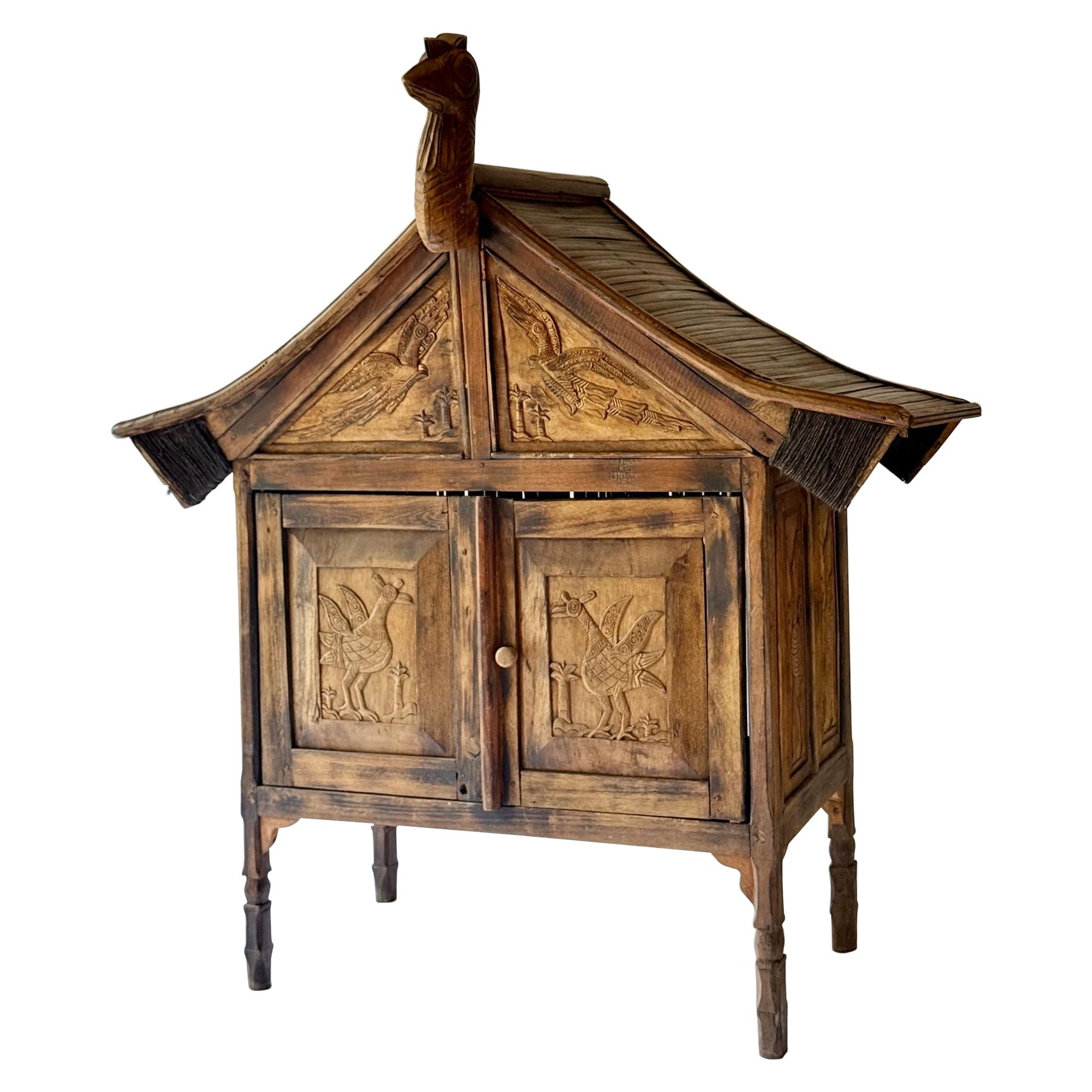 Rare and primitive Sumatran 2 Drawer Cabinet with Bird Carvings on all 4 Sides. For Sale
