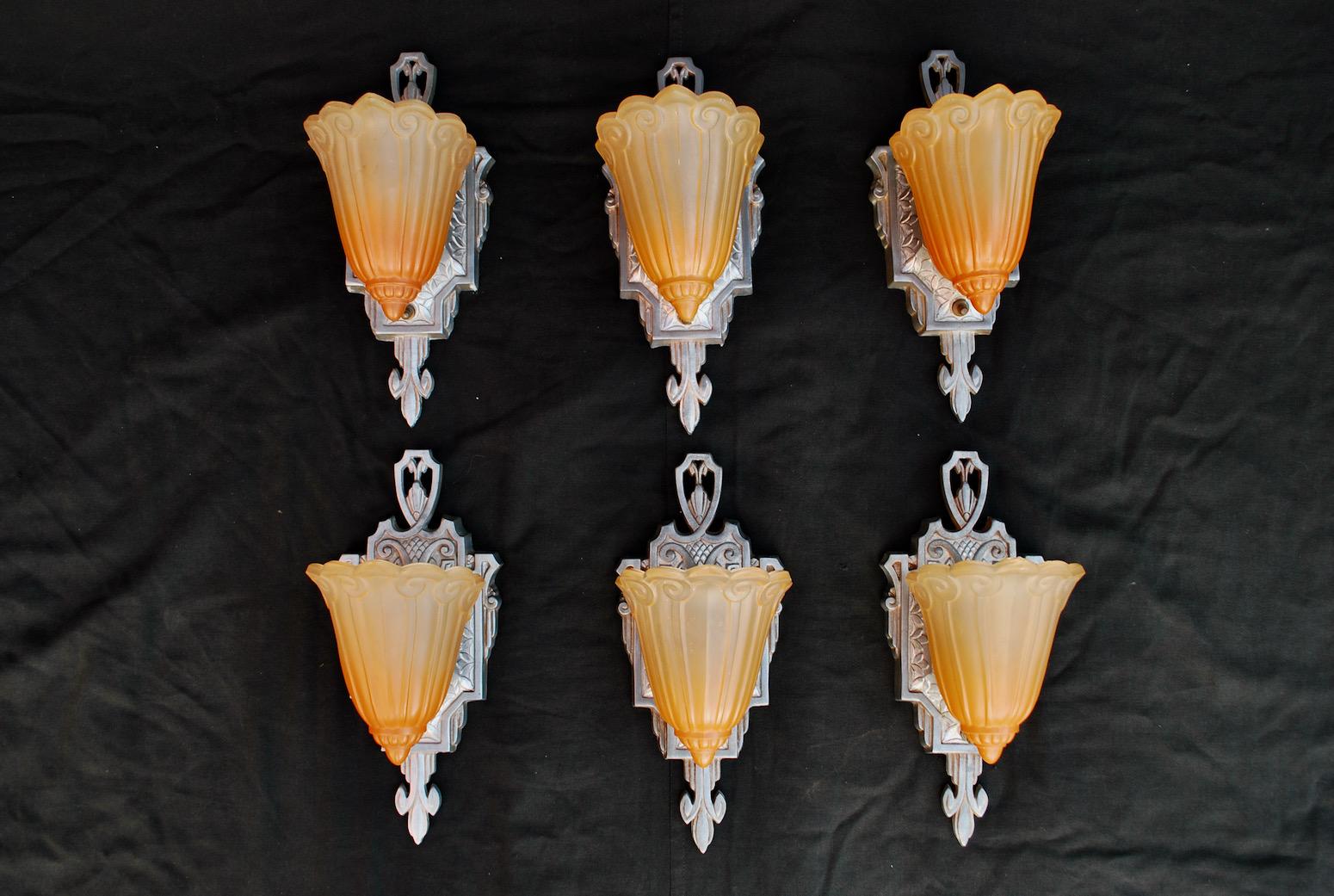 A beautiful and rare set of six Art Deco sconces, the color is not so orange, it is the flash of the camera that is making the color orange so strong, in person it is more softer and not so orangey.