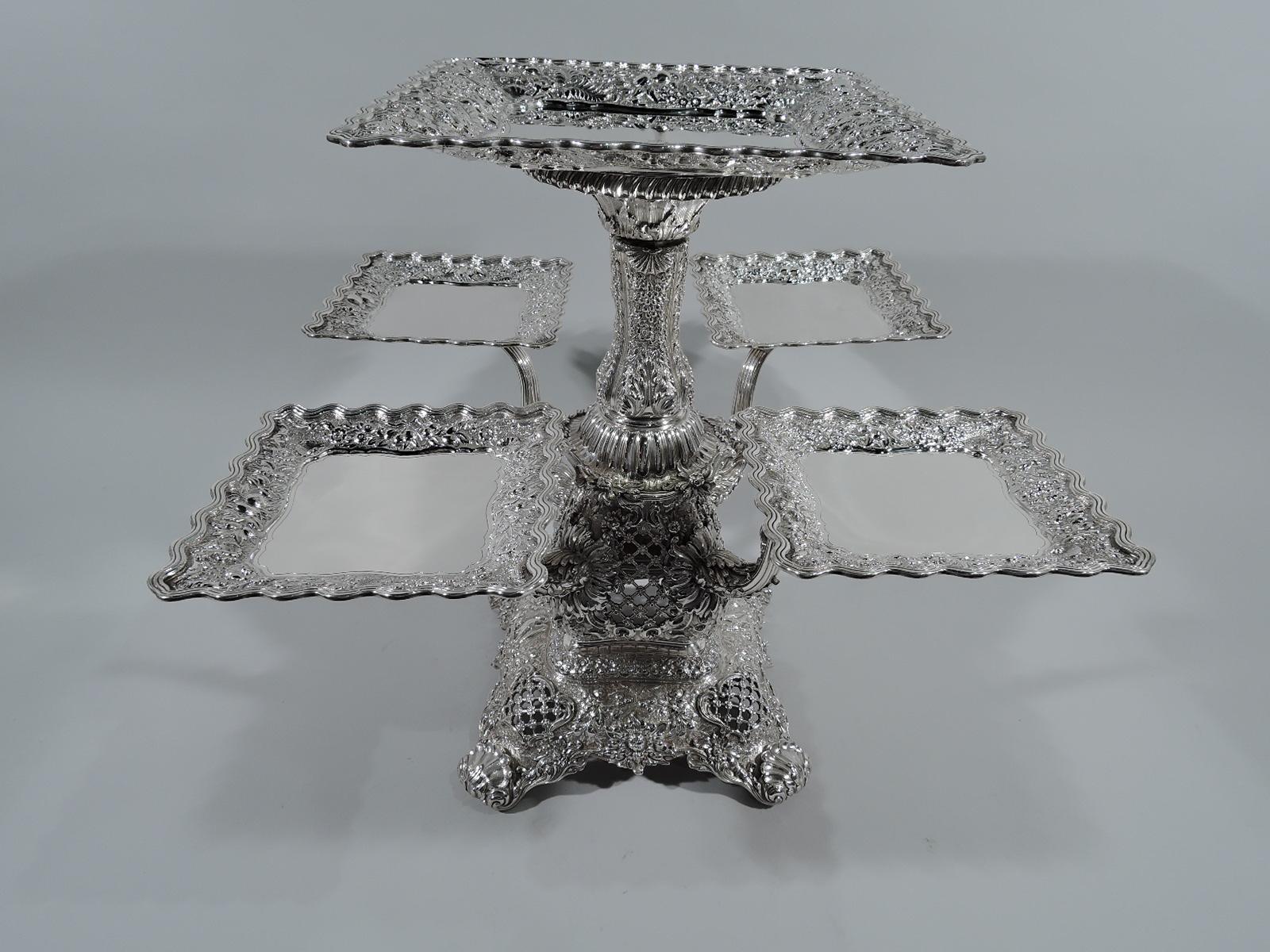 Rare and striking sterling silver epergne. Made by Tiffany & Co. in New York. Baluster shaft with ribbed floral flange quadrilateral raised base with 4 scallop shell-capped supports. Pierced diaper pattern and applied, chased, and repousse dense