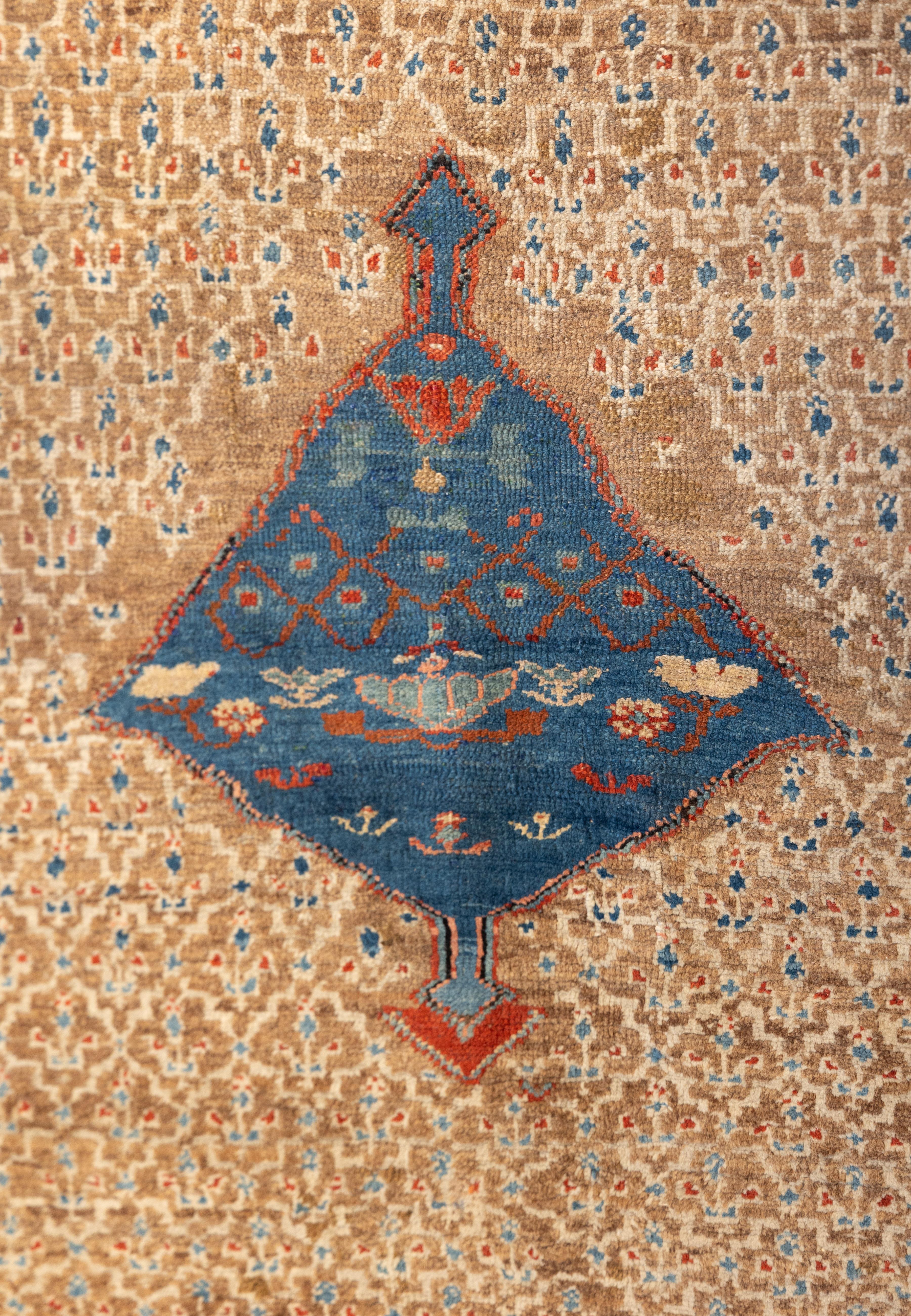 Rare a 19th century camel field Bakshaish featuring a fine, allover lattice of tiny ivory tribal motifs on a warm, coppery brown ground. A single primitive rich blue diamond medallion floats in the center, adding contrast and focus. Delicate white