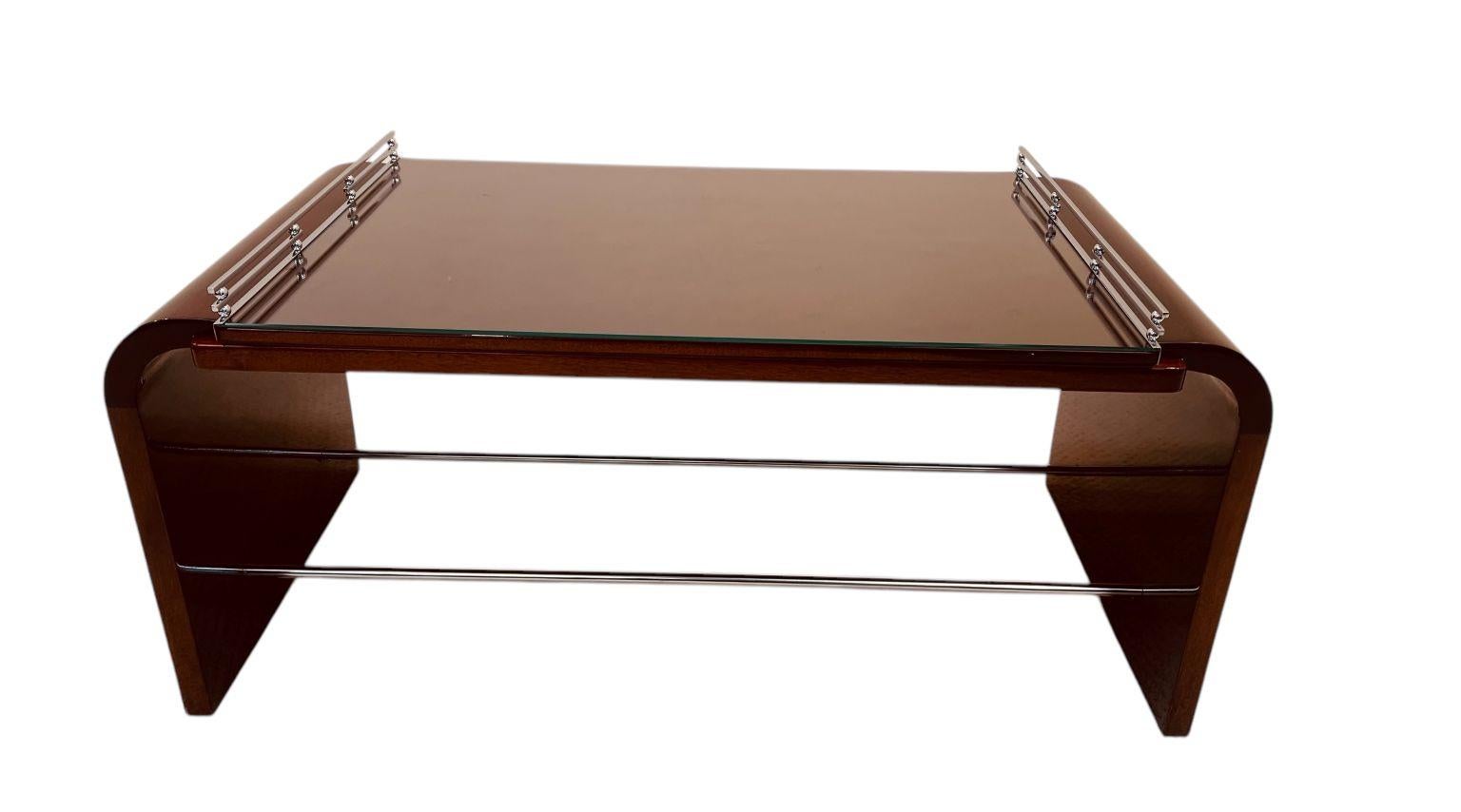 A beautiful and rare Burl Walnut Machine Age Art Deco cocktail table.  A very unique and stylish seldom seen cocktail table from the 1930’s with a lift off drink or tea tray adorned with beautiful chrome accents. The table is very much in the design