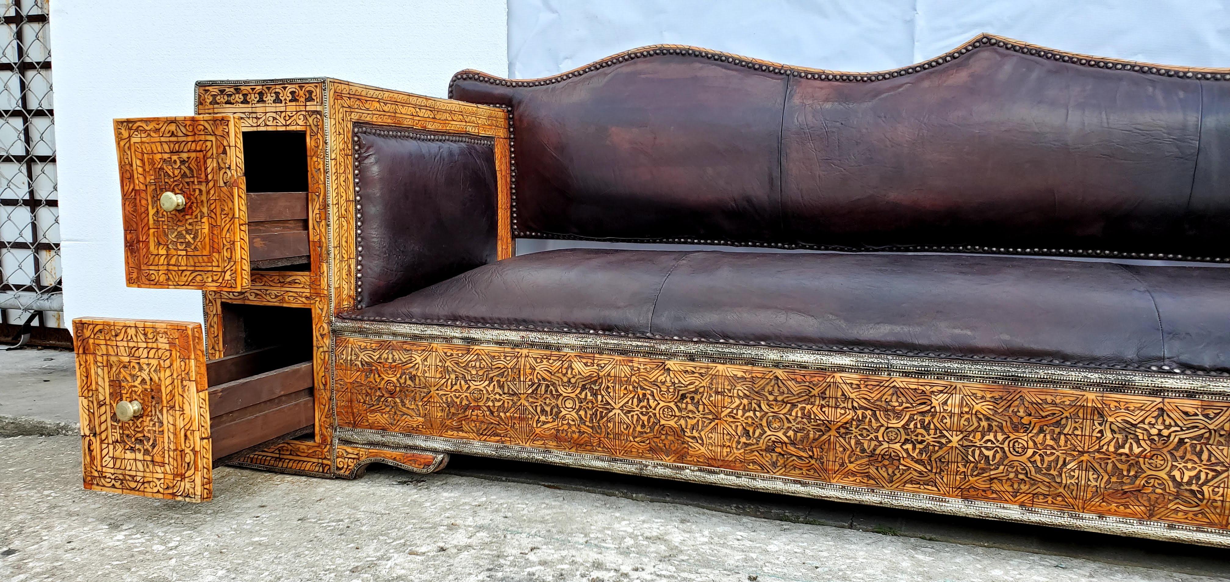 Rare and unique sofa or bench
A statement piece! Perfect for a sitting room, library or office! 
Inlaid camel bone lounge /sofa / bench 
Hand carved henna stained bone. Thick dark hand tanned Moroccan dark leather. 
Handmade in Morocco

Unique