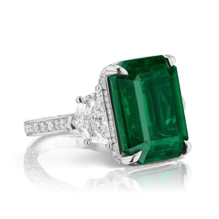 RARE AND UNIQUE ZAMBIAN EMERALD AND DIAMOND RING A simply stunning and substantial (AGL and GIA Certified) Emerald is the star of this classic platinum ring. The 15.81 ct vibrant green Emerald is embraced on either side by a high-quality GIA