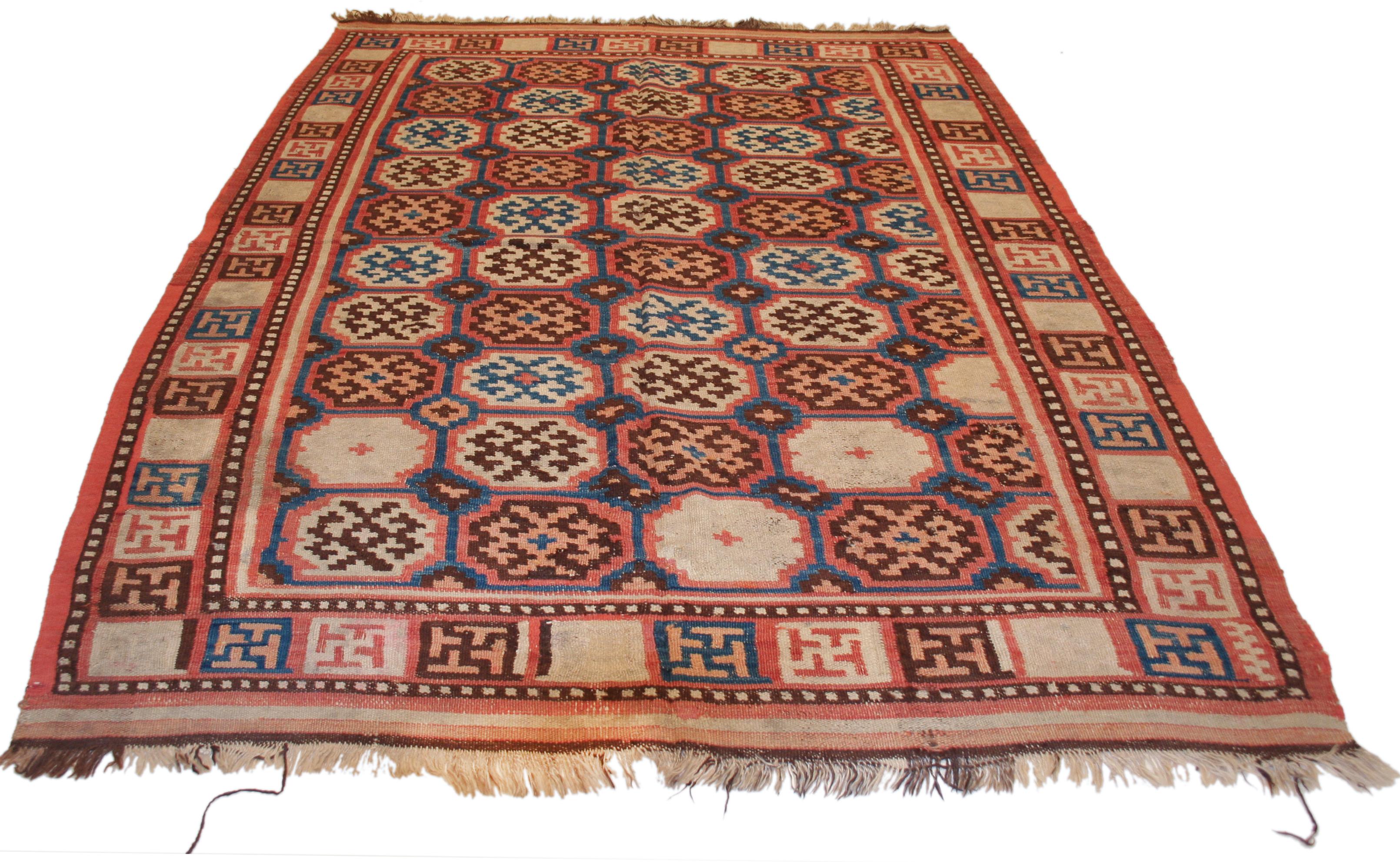 A rare and unusual flat woven cover from the Khotan oasis in eastern Turkestan, distinguished by a honeycomb arrangement of octagons containing polychrome stepped lozenges with hooked extensions. We see similar patterns in the early pile rugs of