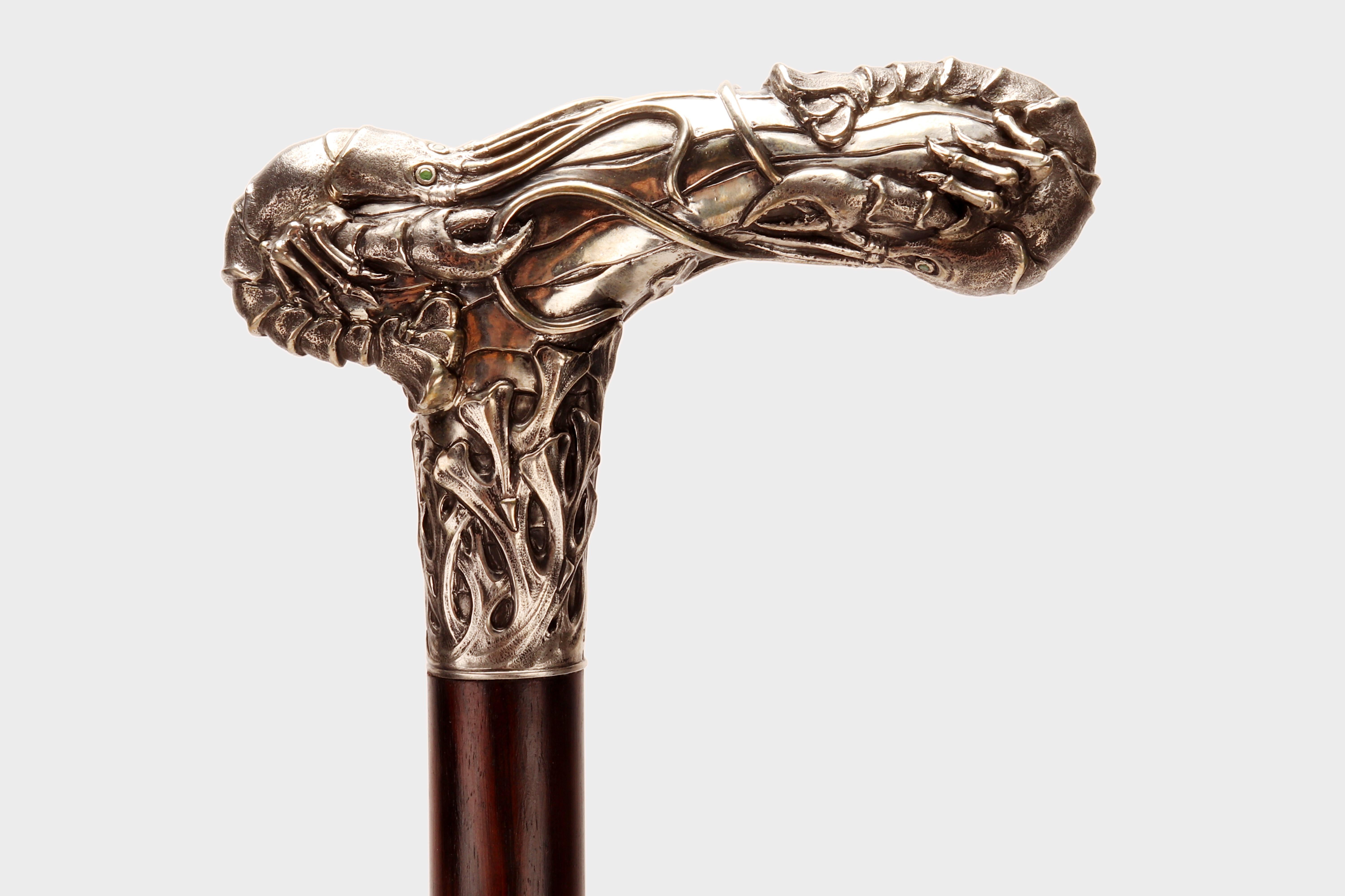 Exceptional Art Nouveau walking stick. A rare jeweled stick, L-shaped knob in 800/1000 silver, with precious stones: emeralds, depicting two lobsters in a marine environment. Ebony wood barrel. Metal tip. Signed, jeweler Christian Fjerdingstad,