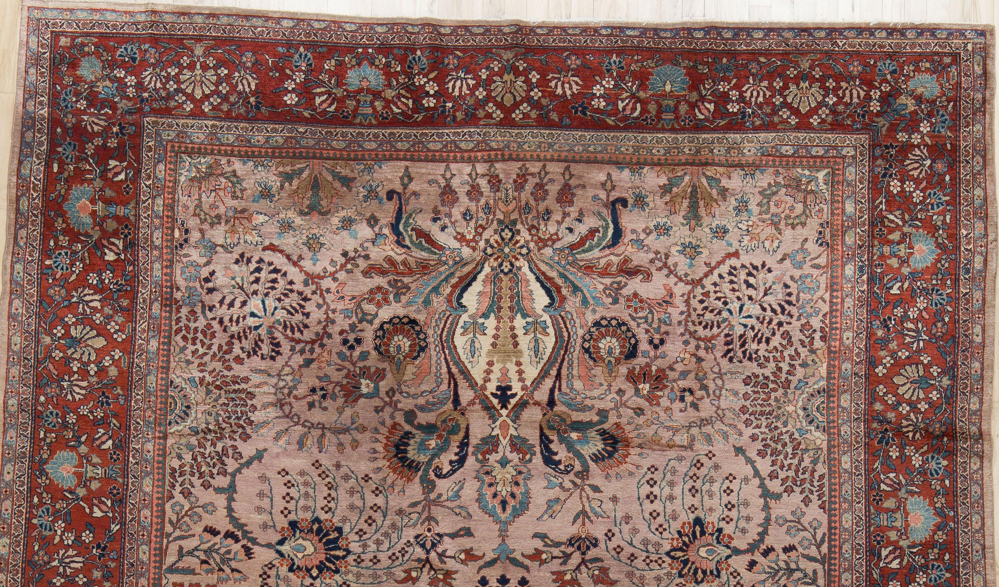 A beautiful turn of the century Ferahan Sarouk with a rare pink field color. A delicate floral design and madder red border. A finely woven carpet with a low, even wool pile. Naturally dyed and preserved. 