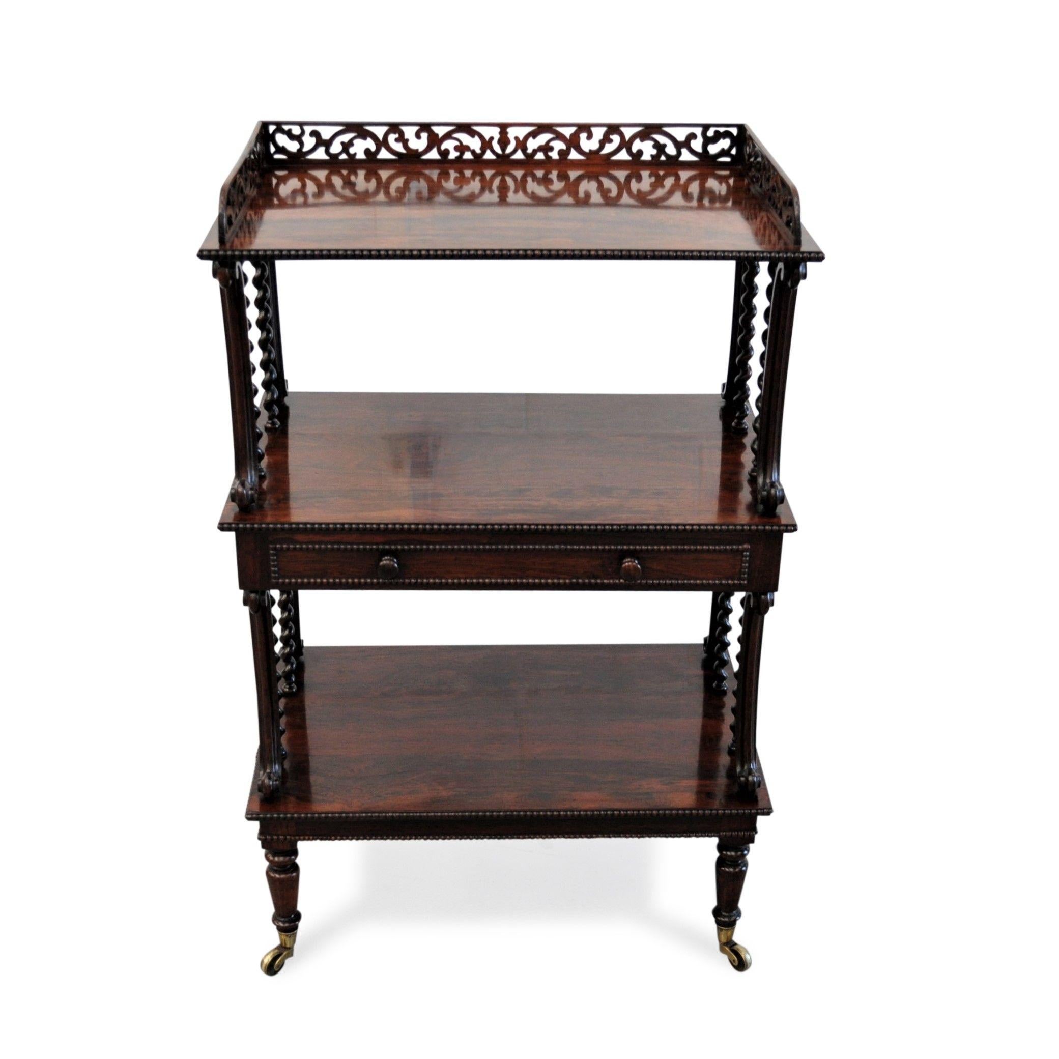 A fine and rare Regency three tier Etagere attributed to GILLOWS constructed in Gonçalo Alves (Tigerwood), with each shelf edged in close bead-work. The top tier with three-quarter fret-work gallery and the middle tier fitted with a drawer below and