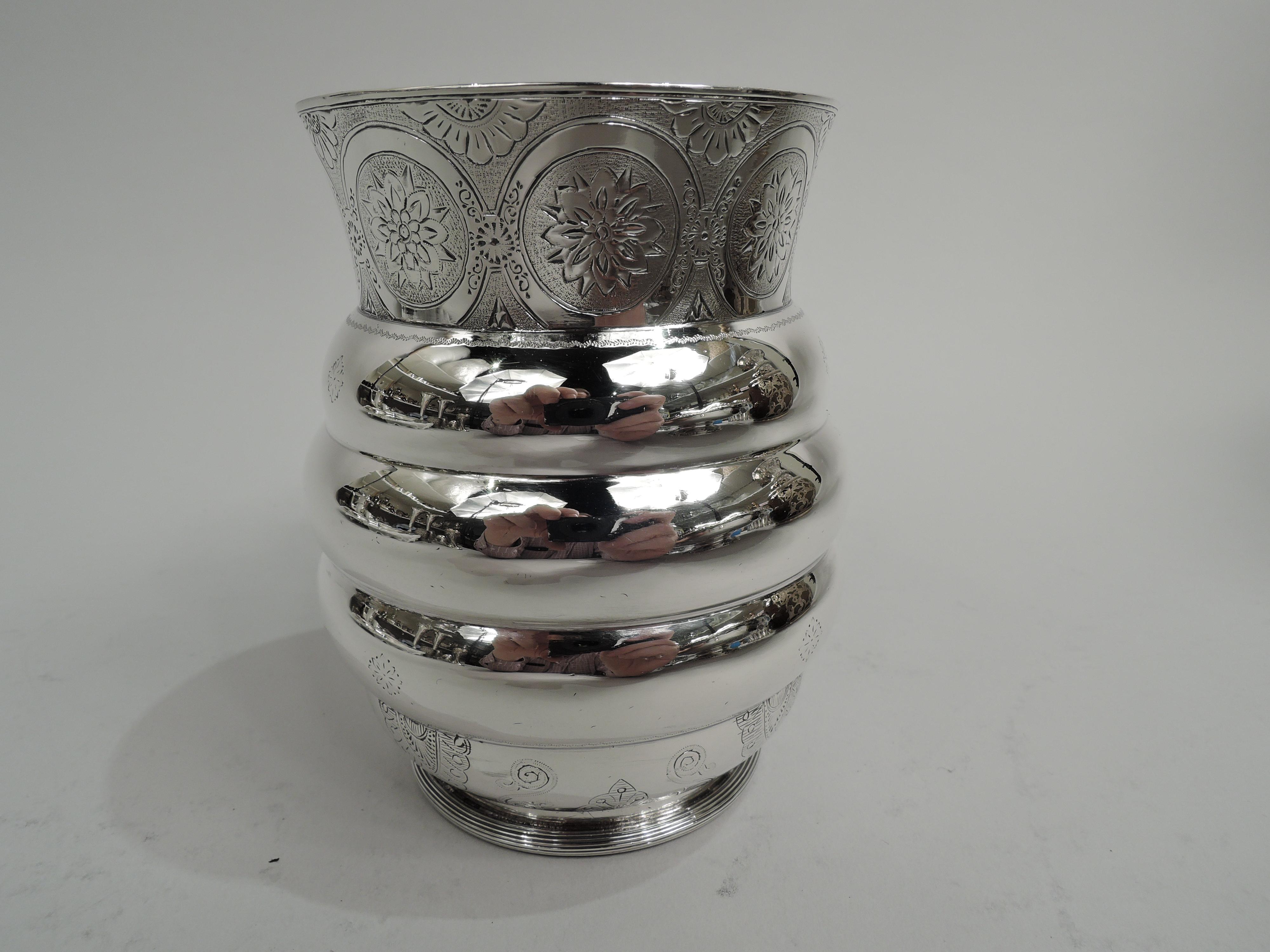 Rare and unusual Aesthetic sterling silver baby cup. Made by Tiffany & Co. in New York. Beehive-form with lobed rings; tapering neck, c-scroll handle with elongated split mount and bands, and raised and reeded foot. Engraved stylized ornament on