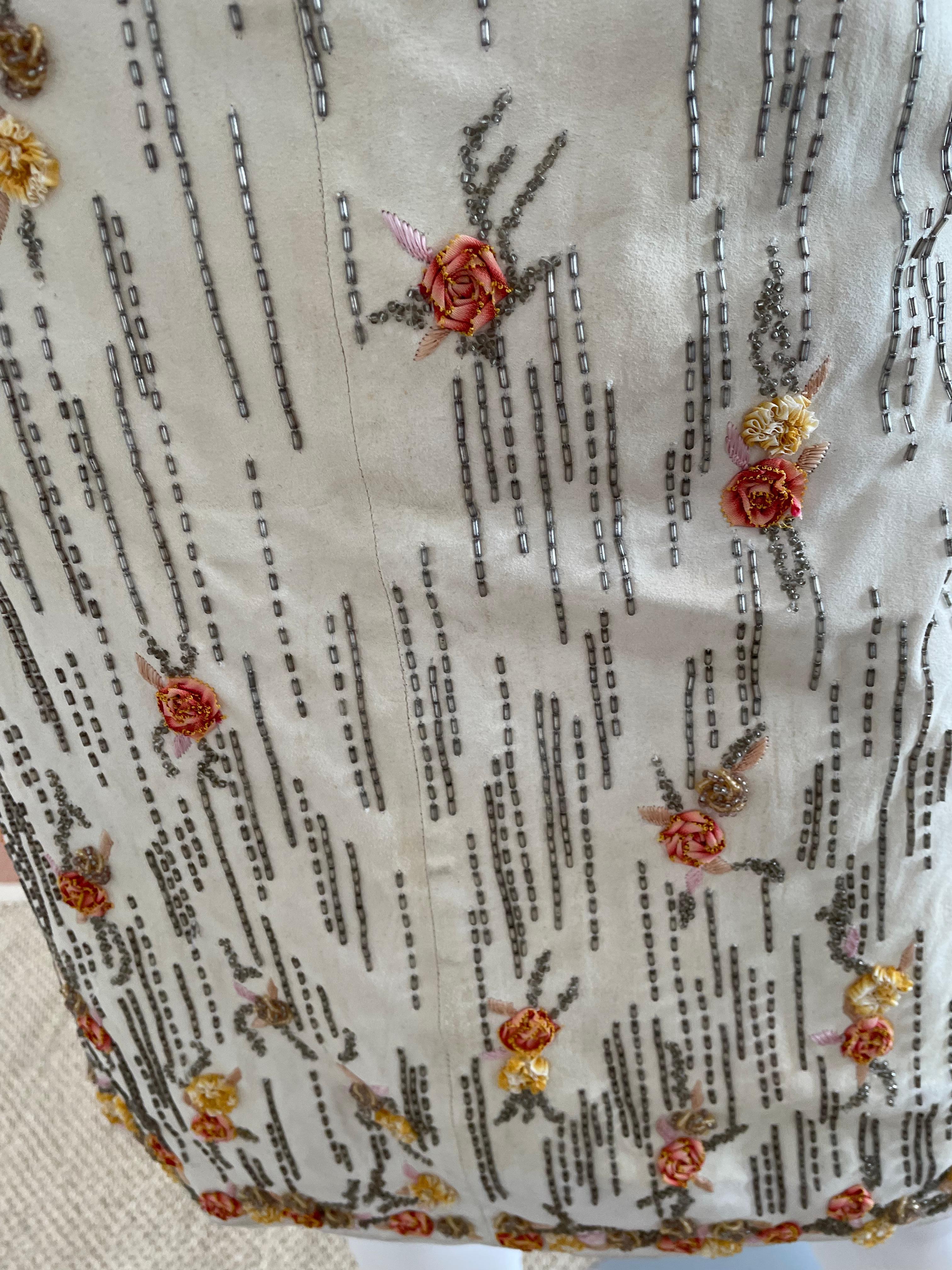 Vintage and rare Valentino Boutique Suede Skirt with Beaded Floral embellished trim. Tags still attached! Slight pen marked shown in the pictures. Originally $8000! Light beige suede. 100% lambskin. Size US 4. Made in Italy.