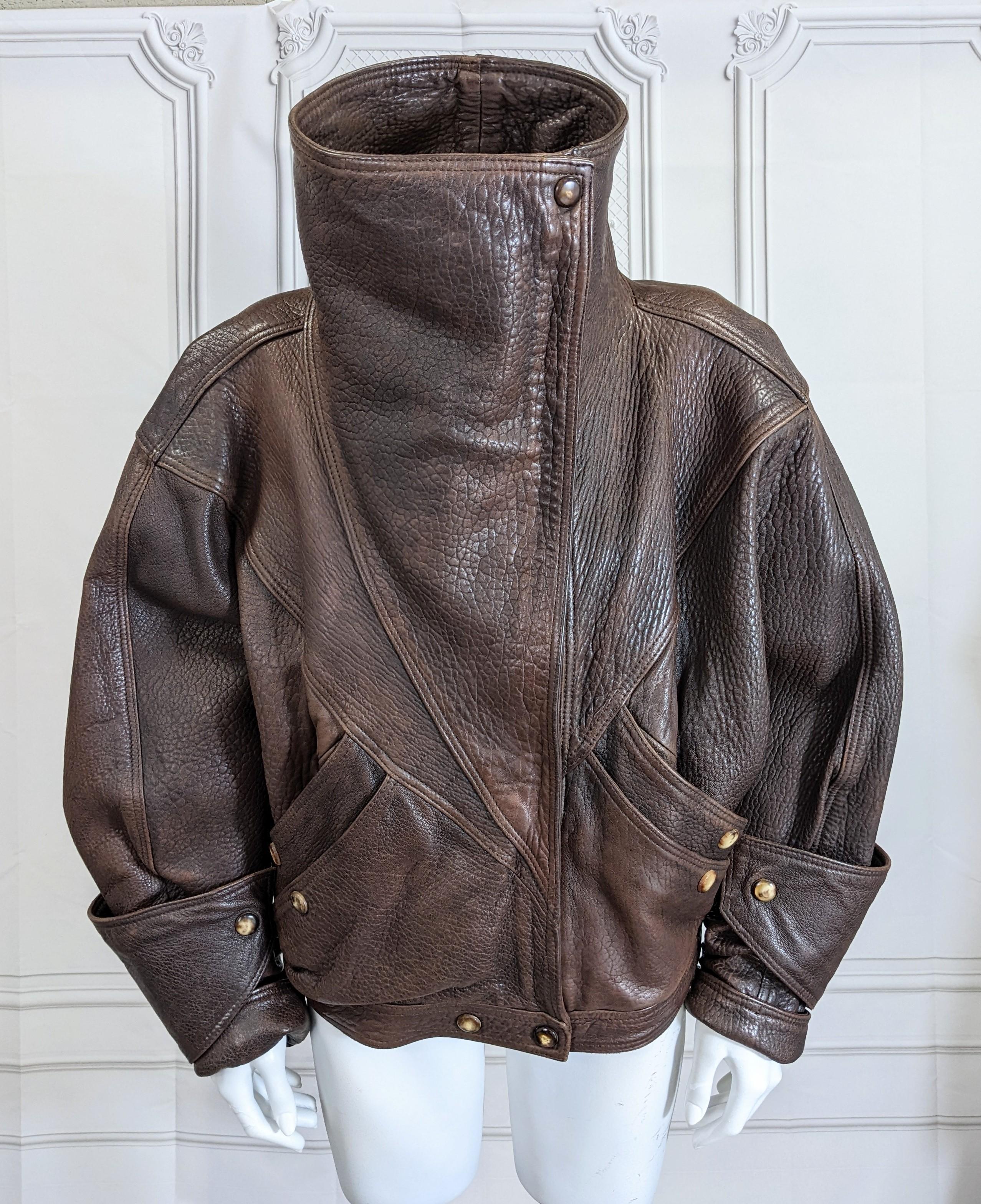Rare, iconic Anne Marie Beretta bomber jacket in brown buffalo textured leather with extraordinary signature detailing such as her funnel collar and shark's fin wristlets.
One of the most under rated Parisian designers of the 80's, Beretta appealed