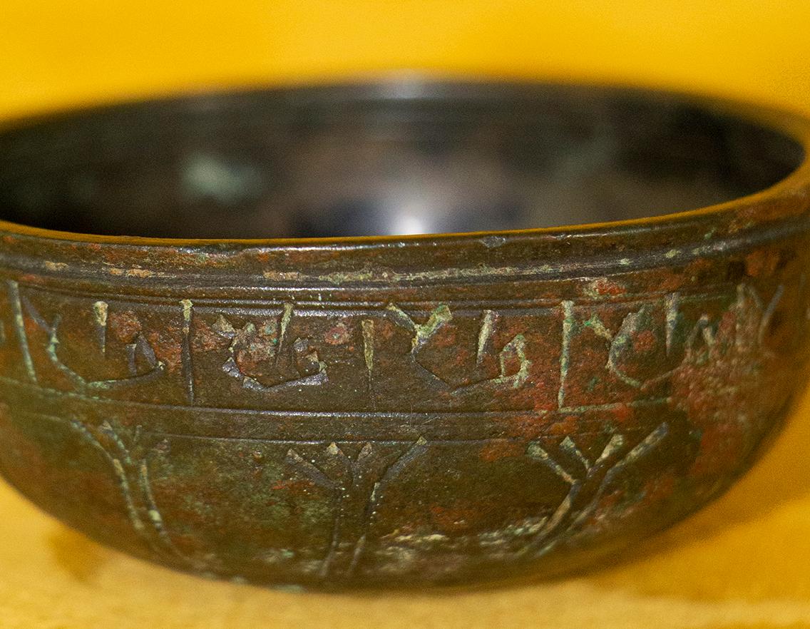 Very rare small Judaic cup from medieval period used for the Kiddush ceremony and also probably for circumcision. This chiseled bronze cup is decorated on its belt, with Hebrew characters. The back of the cup is decorated with the Star of David. The