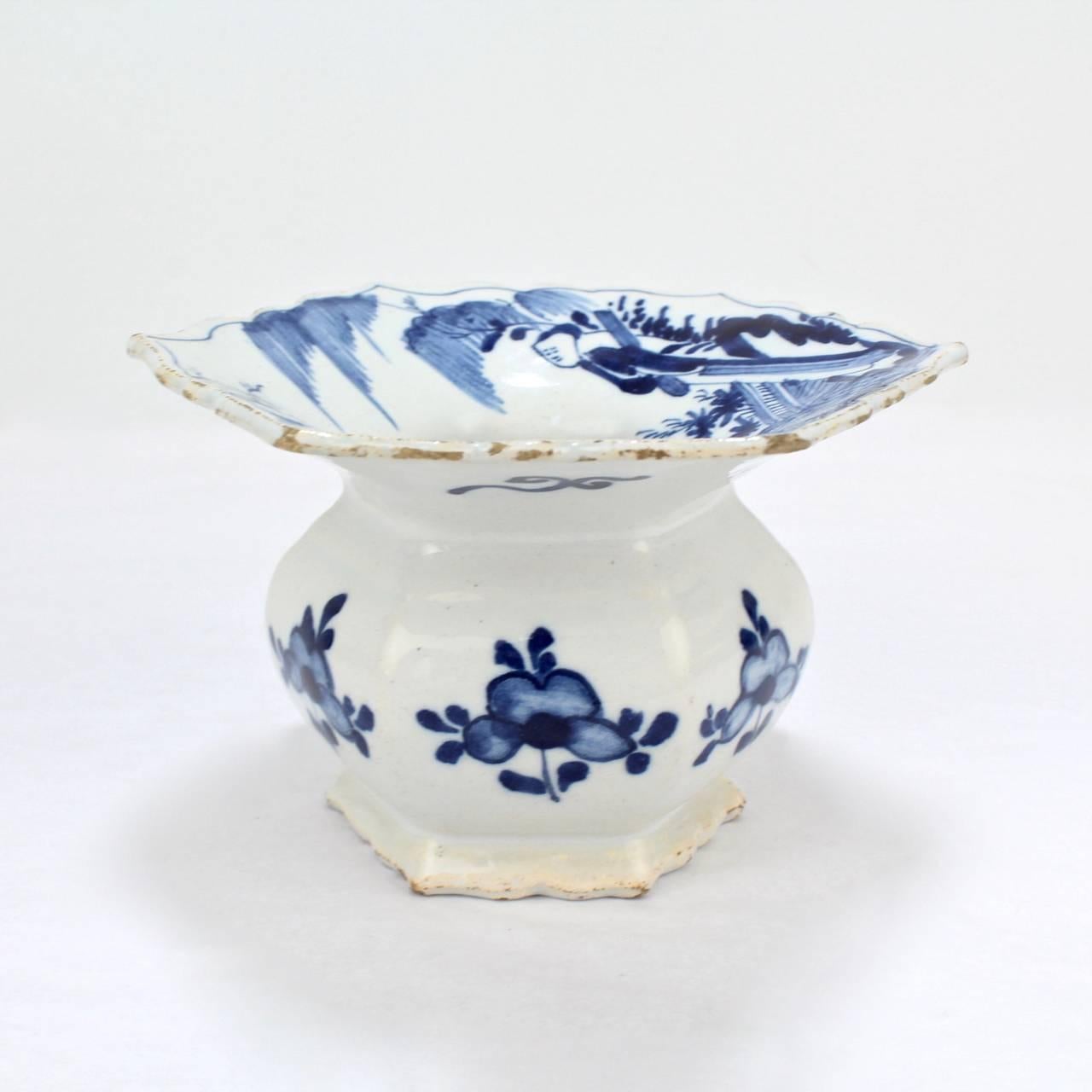 A very fine 18th century Dutch delft pottery spittoon. 

Decorated in blue with flowers to the sides and chinoiserie decoration to the top.

Measures: Diameter circa 4 3/4 in.

Provenance: From the estate of the prominent Lucas family of