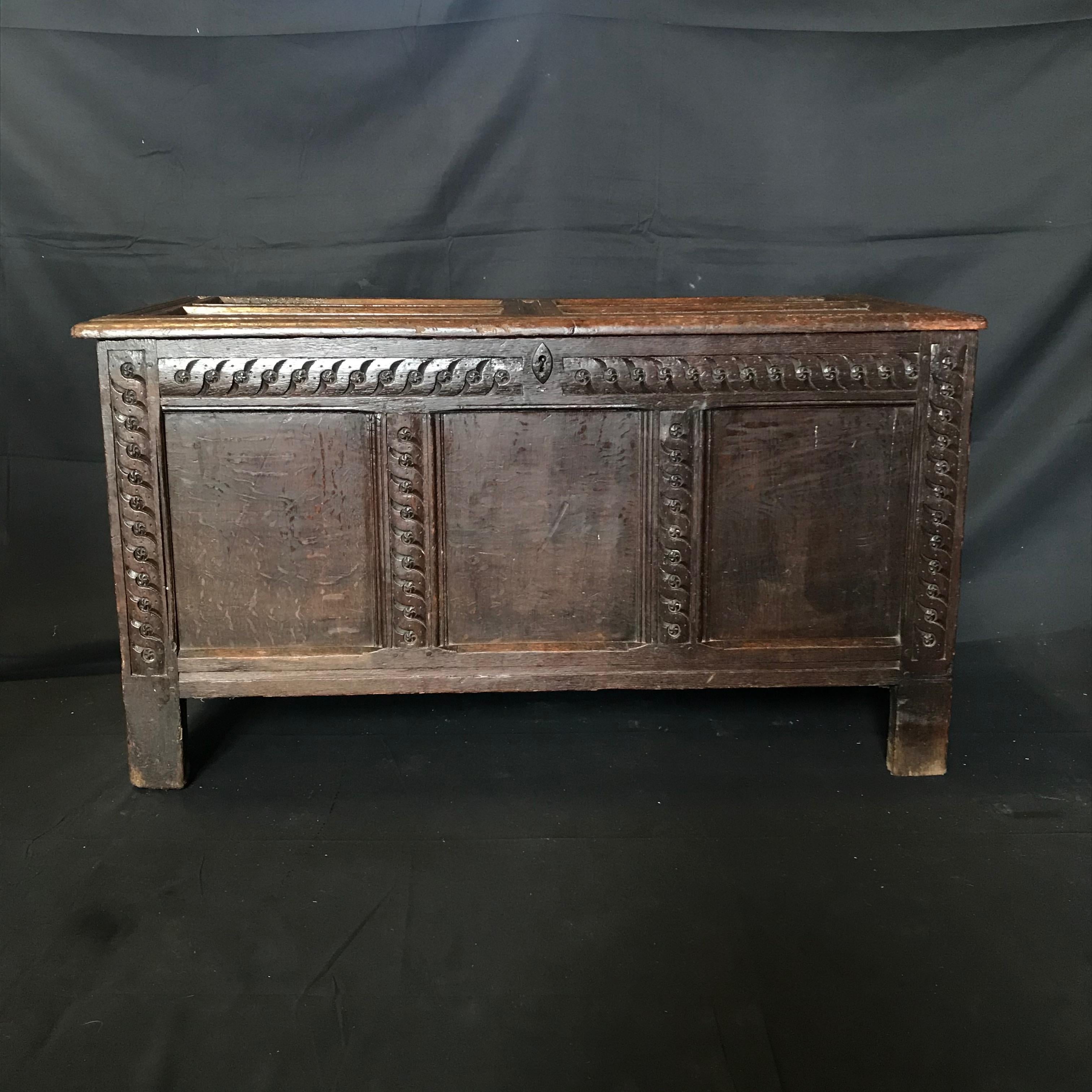 18th century paneled oak Scottish coffer, with three panels to the front, two panels to each side, raised on stile feet, original steel lock plate and hinges, gorgeous rope weave pattern surrounding panels, lovely color and patina and great
