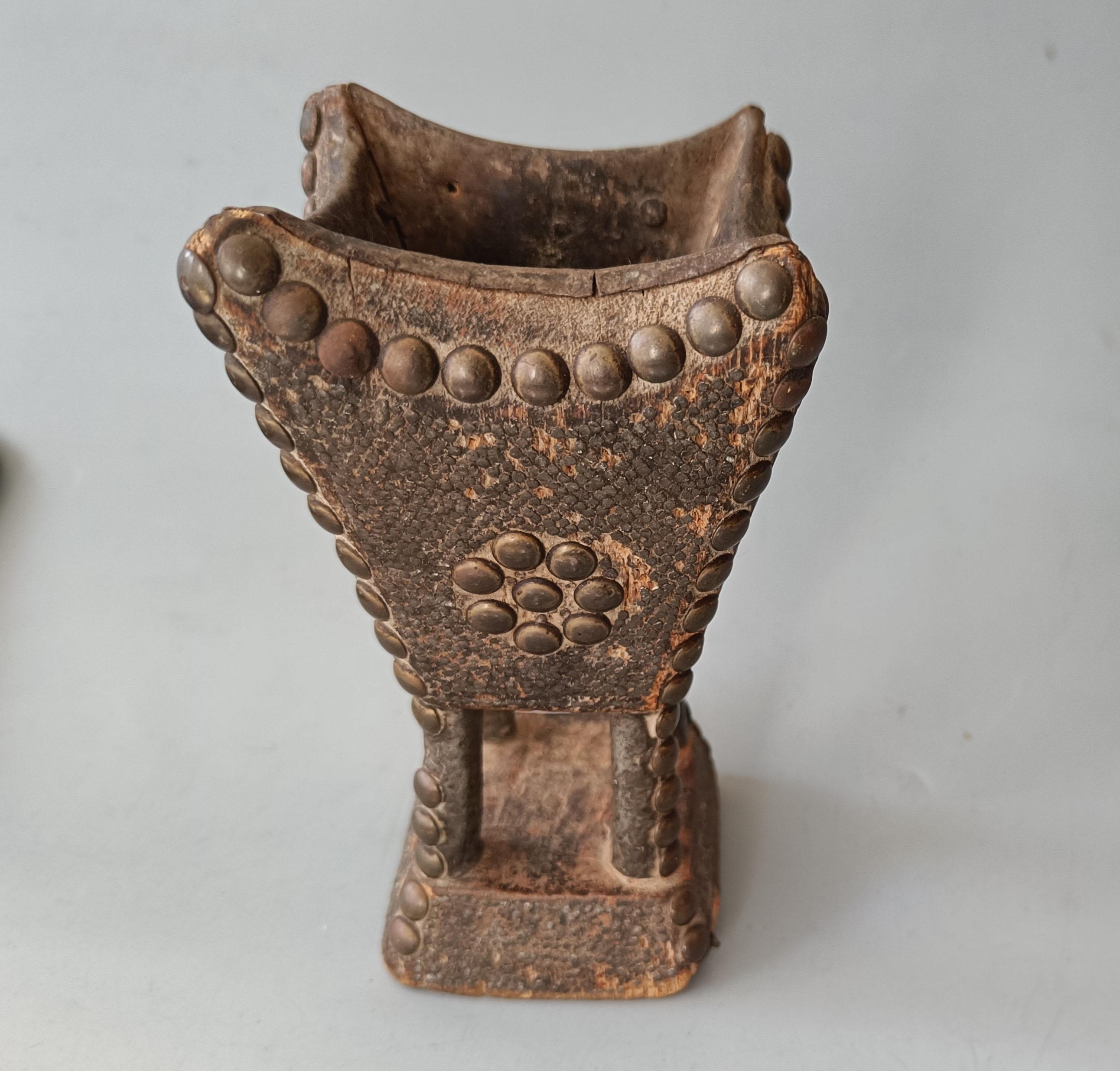 Rare old 19th century Bedouin Mabkhara Incense burner
Carved wood the surface covered with many small metal studs emulating  snake skin with larger brass studs and metal liner
A superb early 19th Century example 
Height 17 cm

 
 
 