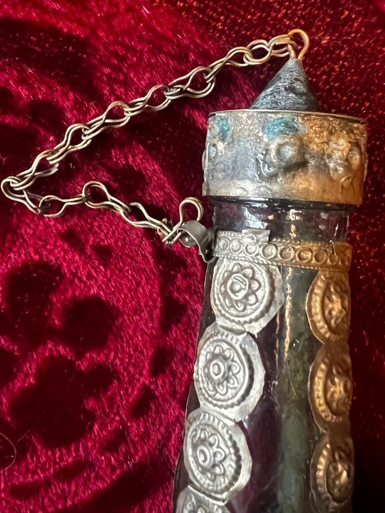 This is a very rare antique bronze and hand blown glass bottle measures 26cm in hight and 9 cm in width. The bottle is extremely rich decorated and has a cup on top. This is a very charming antique piece and can be used as an oil or vinger bottle or