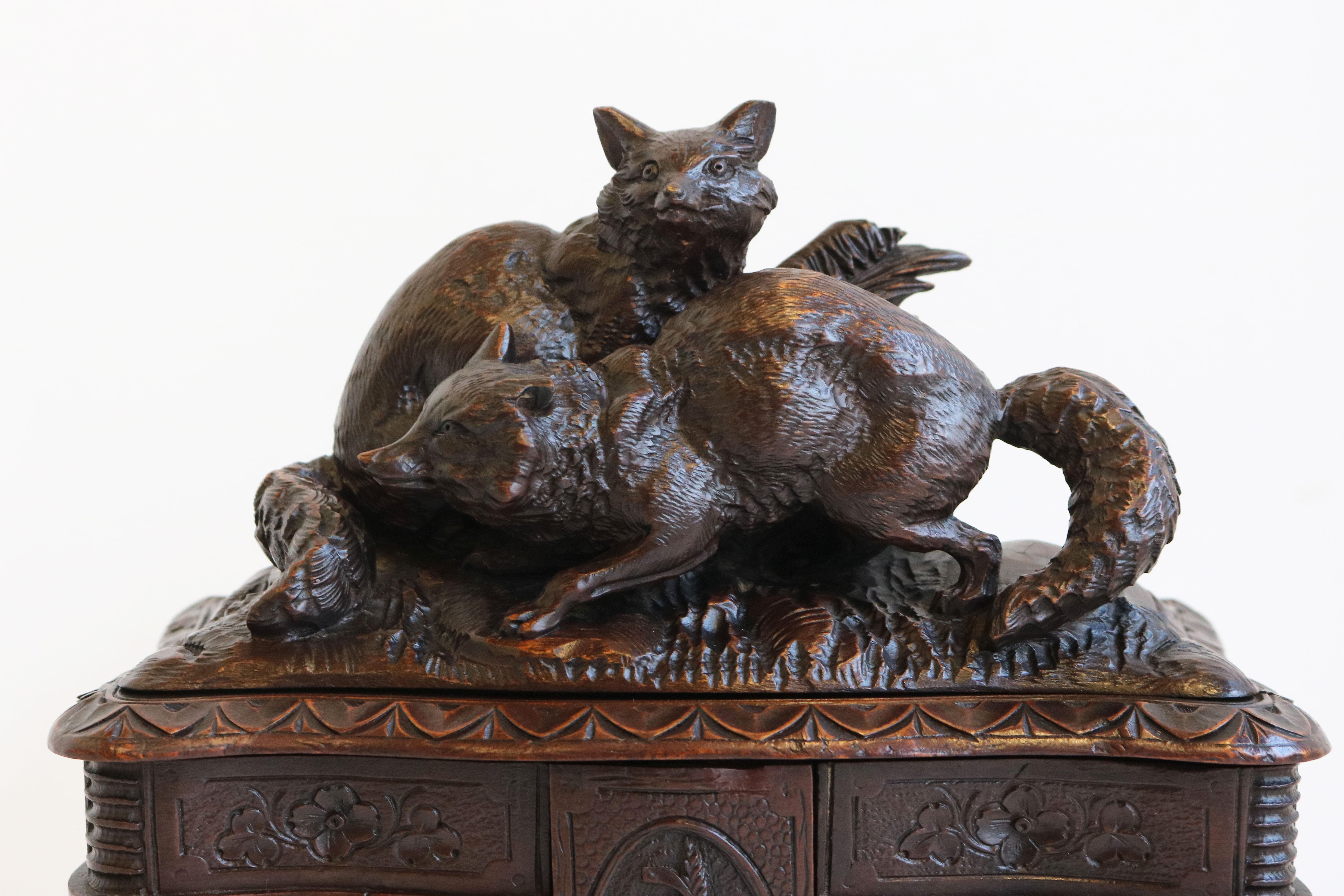 A beautiful, very finely carved antique black forest jewelry box from the late 19th/ early 20th century made in Switzerland. 
A large and impressive four-tiered piece with 6 swing out shelves. Fully hand-carved out of Fruitwood. 
Each part is