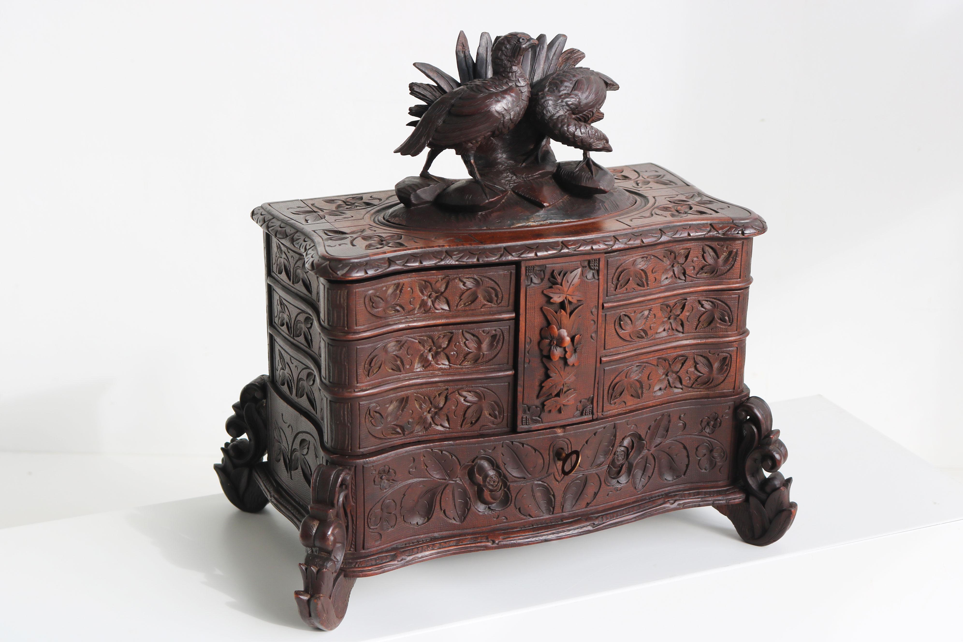 A beautiful, very finely carved antique black forest jewellery box from the late 19th/ early 20th century made in Switzerland.
A large and impressive four-tiered piece with 6 swing out shelves. Fully hand-carved out of Fruit wood.
Each part is