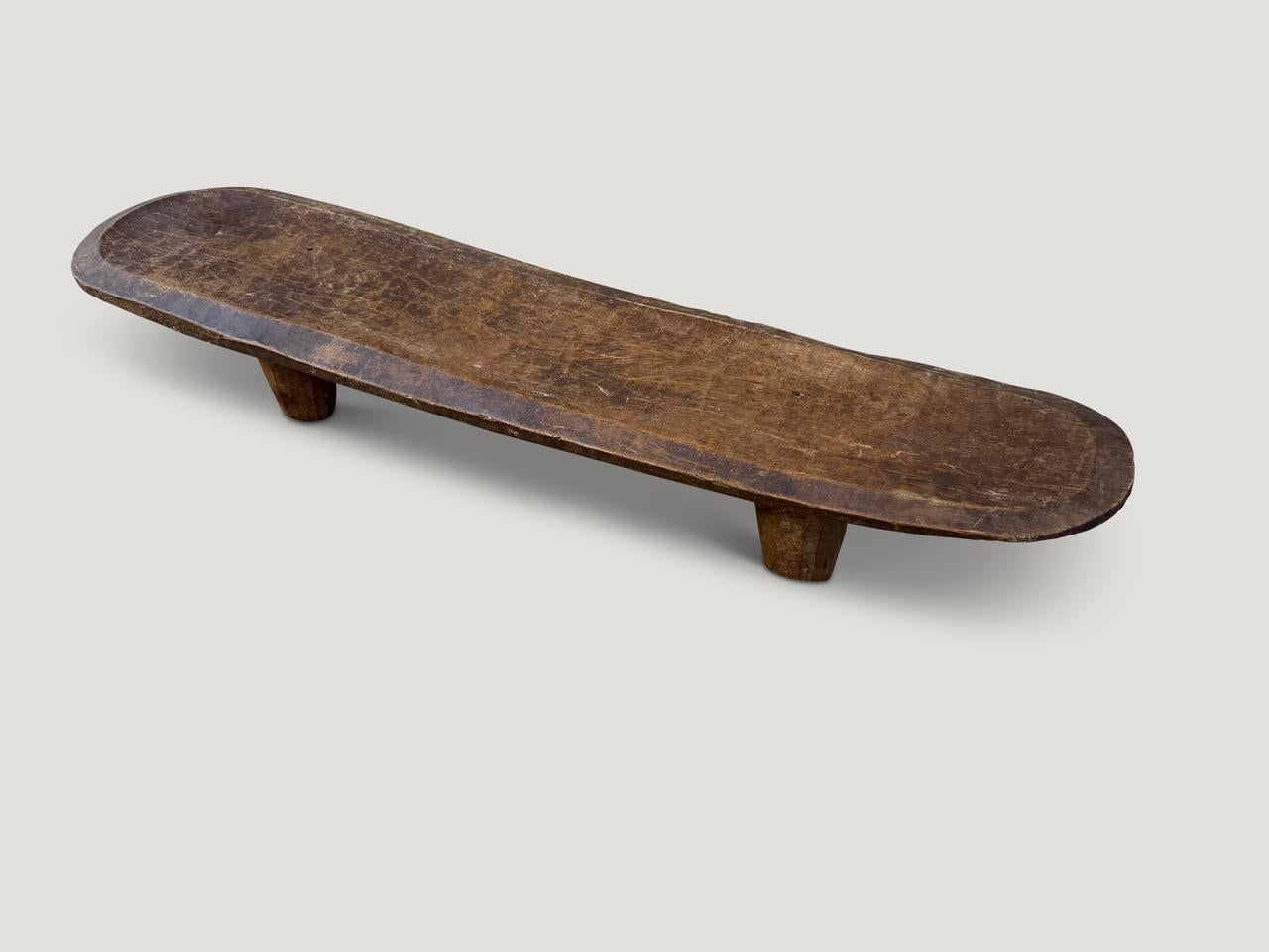 Rare antique coffee table or bench hand carved by the Senufo tribes from a single block of wood, native to the west coast of Africa. The wood is tough, dense and very durable. Originally used as a bed hence the slight graduation in the height. Shown