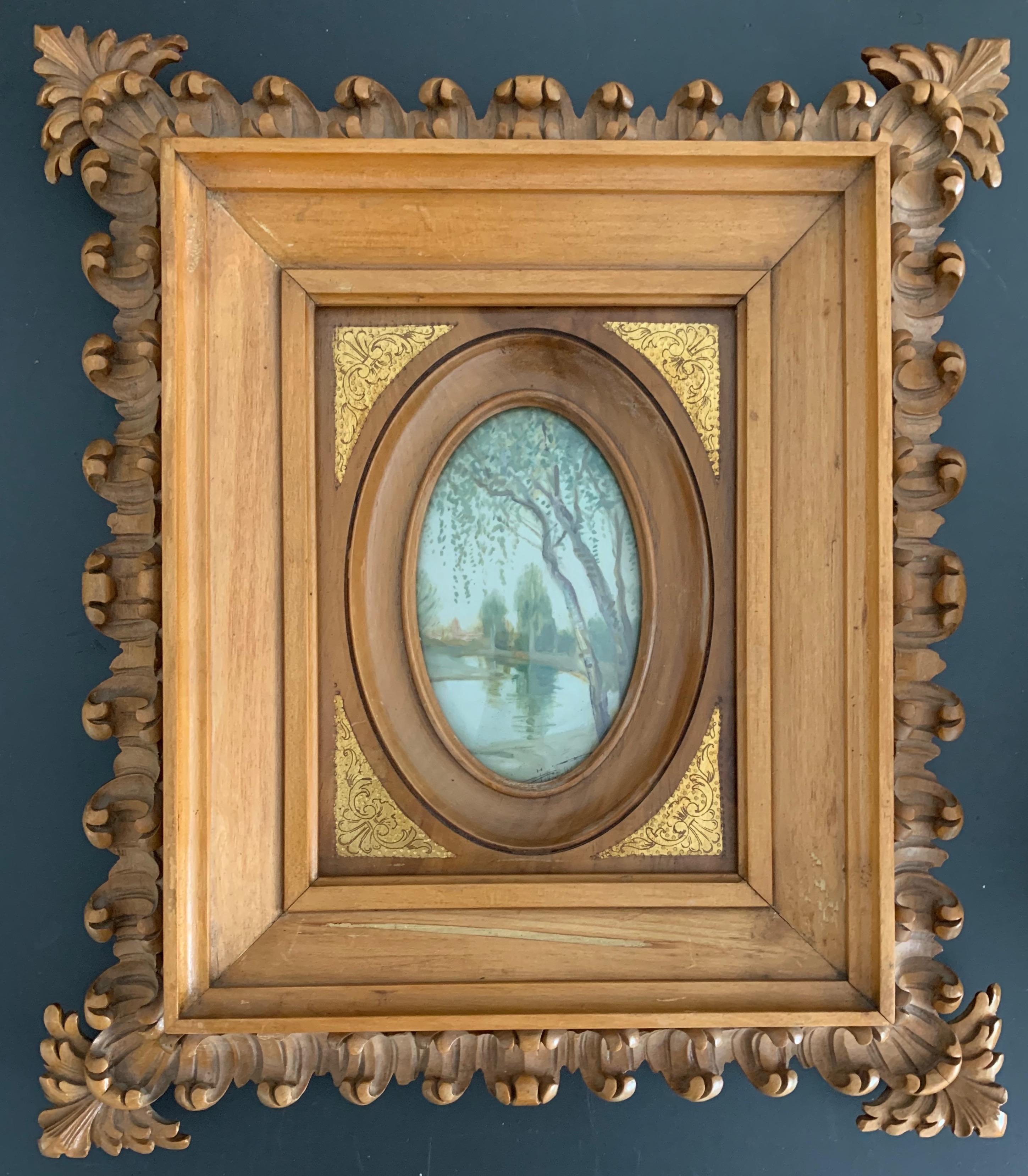 Rare and exceptionally carved picture frame with landscape painting behind convex glass panel.

This unique picture frame is another one of our wonderful recent finds. It truly is a work of art (in more ways than one) and, for us, this rare and