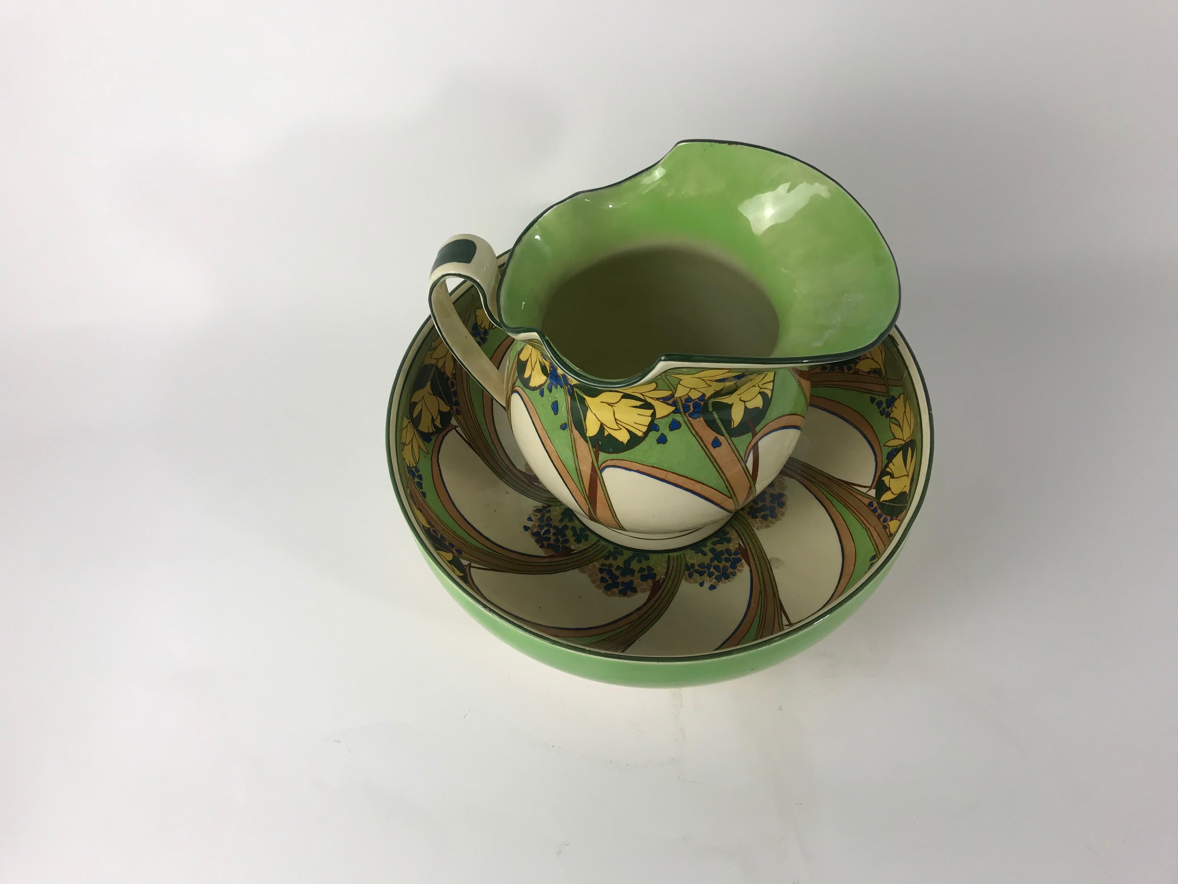A gorgeous Art Nouveau 2-piece wash set collection by Royal Doulton. Swirling with soft colorful tones of yellow and green and sharp deep blue hues. This set is a match made in heaven with the simplicity of the deep, wide green bowl clashing