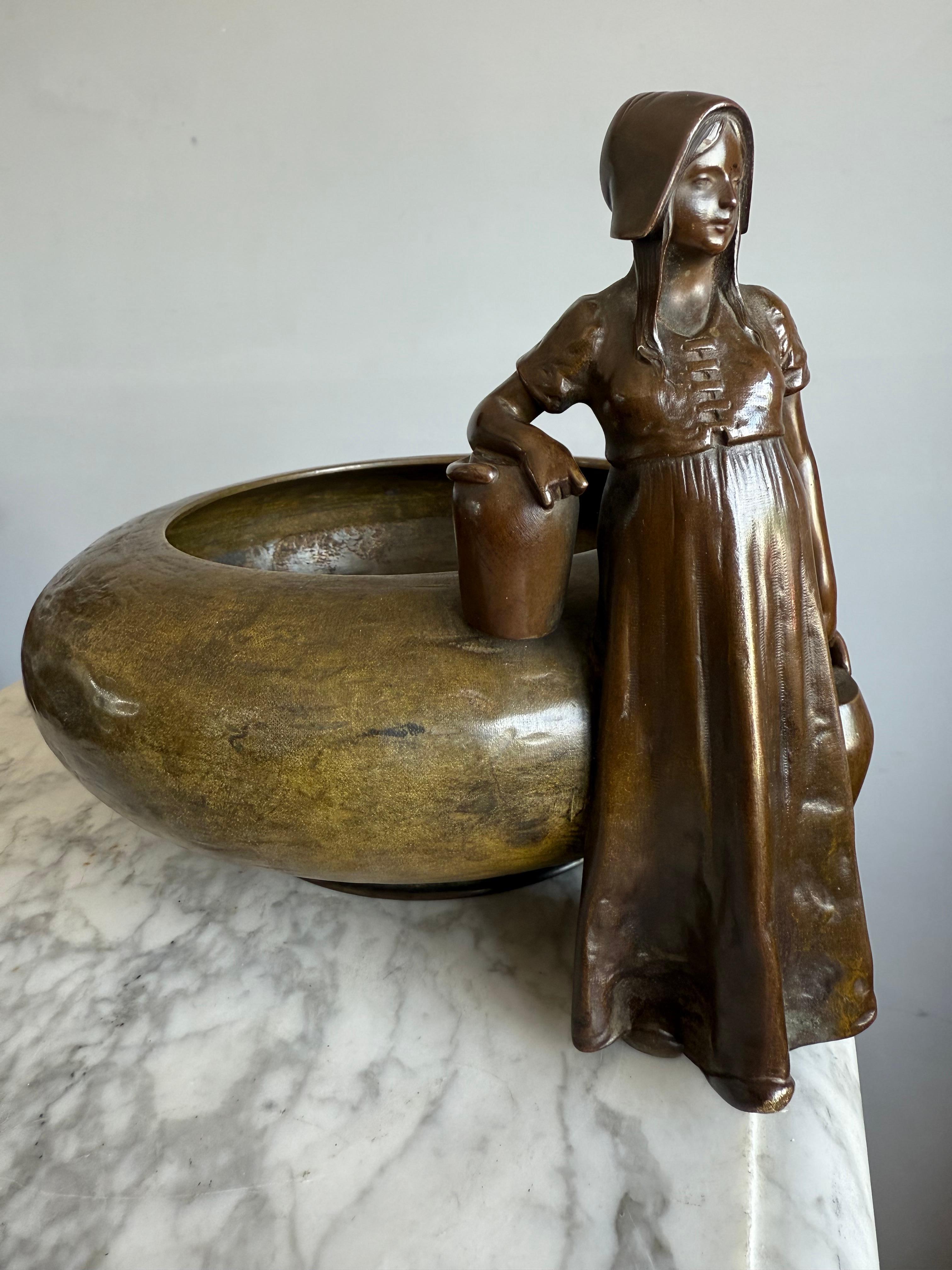 Austrian Jugendstil bronze centerpiece with country girl figure, circa 1900.

Step into the poetic world of late 19th-century Austria with this captivating bronze jardinière, an exquisite marriage of function and artistry. Sculpted in the romantic