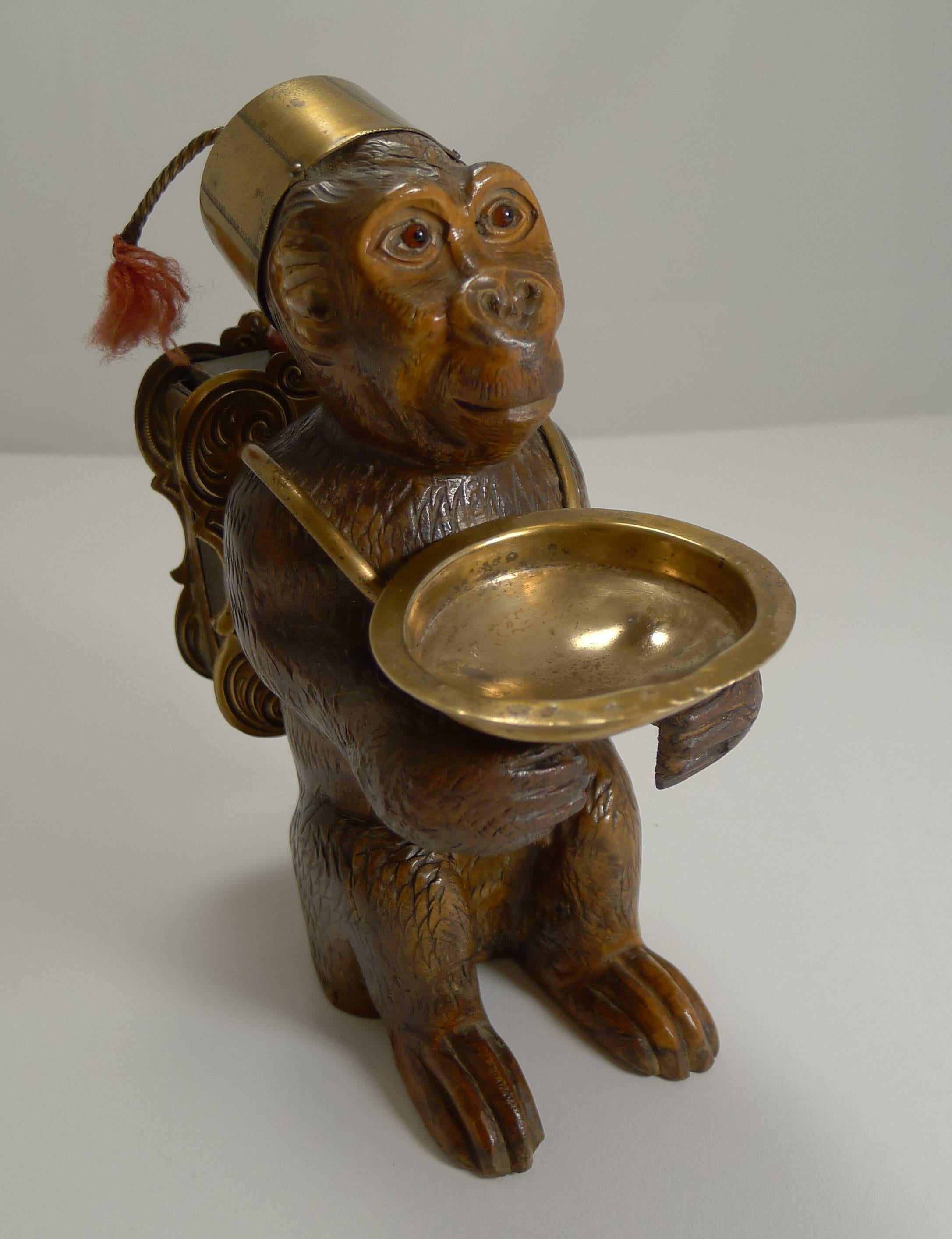About as charming as a piece of hand-carved black forest comes, this wonderful piece is beautifully carved in the form of a monkey with intricate detail and beautifully executed.

The monkey holds a brass matchbox holder on the back with a putt to