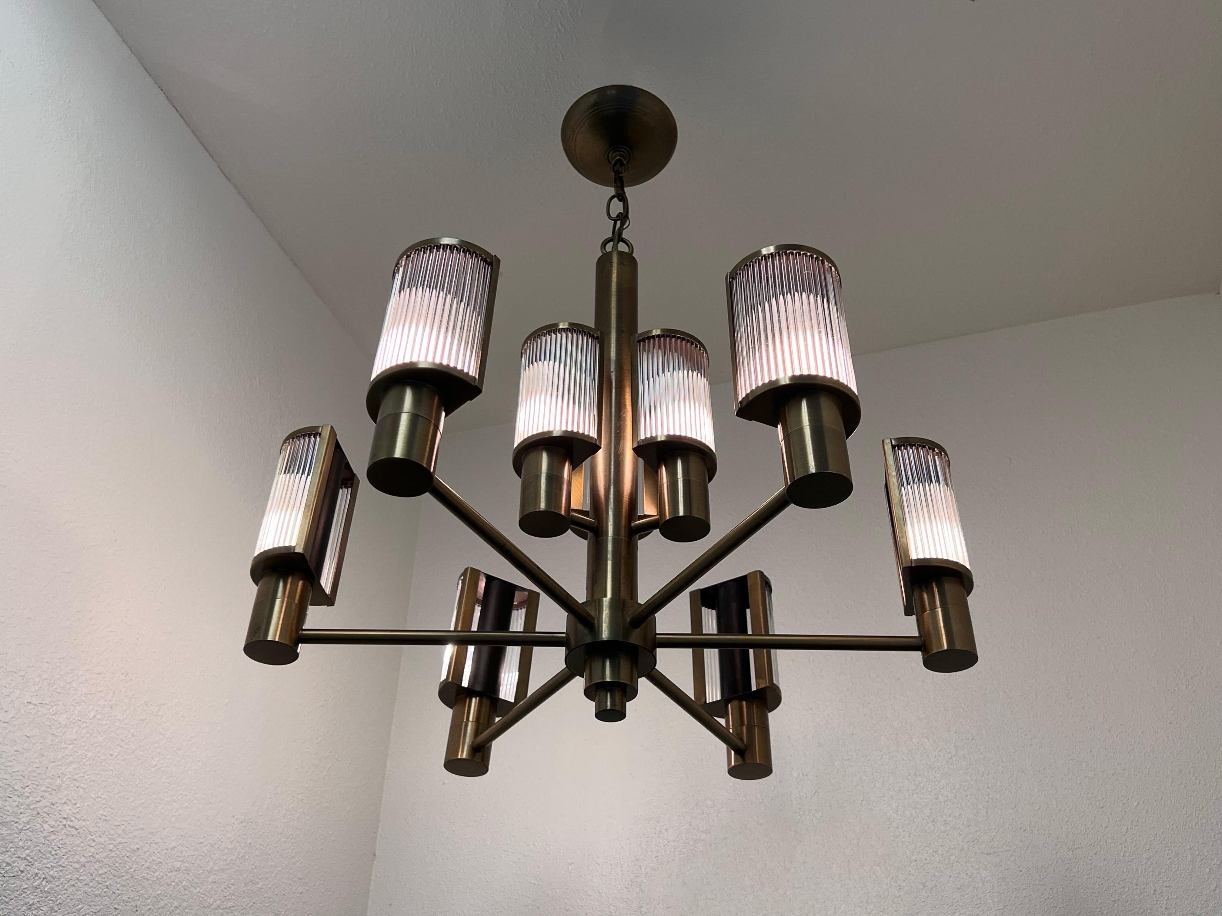 Rare nine arm chandelier by Casella Lighting. 
Constructed of glass rods and solid brass with antique brass finish. 
In original vintage condition shows minor wear consistent with age(see detail photos). 
The measurements are 24” in diameter 21.5”