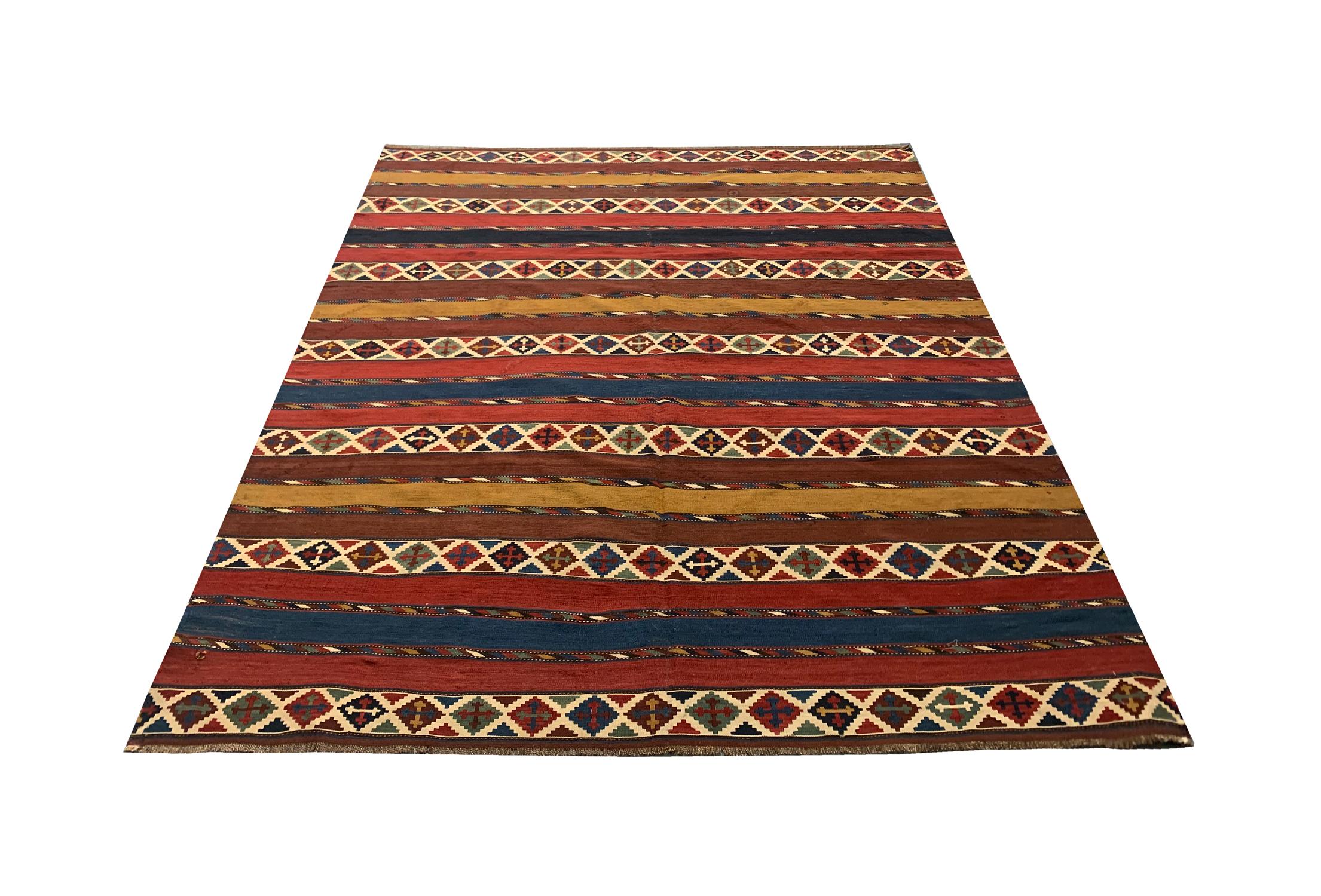 This beautiful striped Caucasian Kilim rug is an antique piece woven in the 1920s with fine, hand-spun wool. The colours in the wool come from natural dyeing techniques which have been used for generations. The design reveals a simple stripe