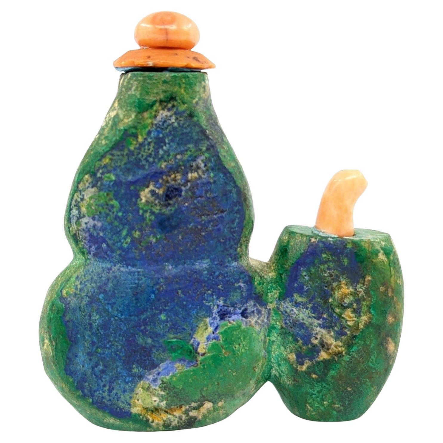 Discover a piece of history with this 19th-century double snuff bottle, hand carved from the captivating azurite malachite stone, renowned for its vibrant interplay of green and purplish-blue hues, a true spectacle of nature's artistry.

This snuff