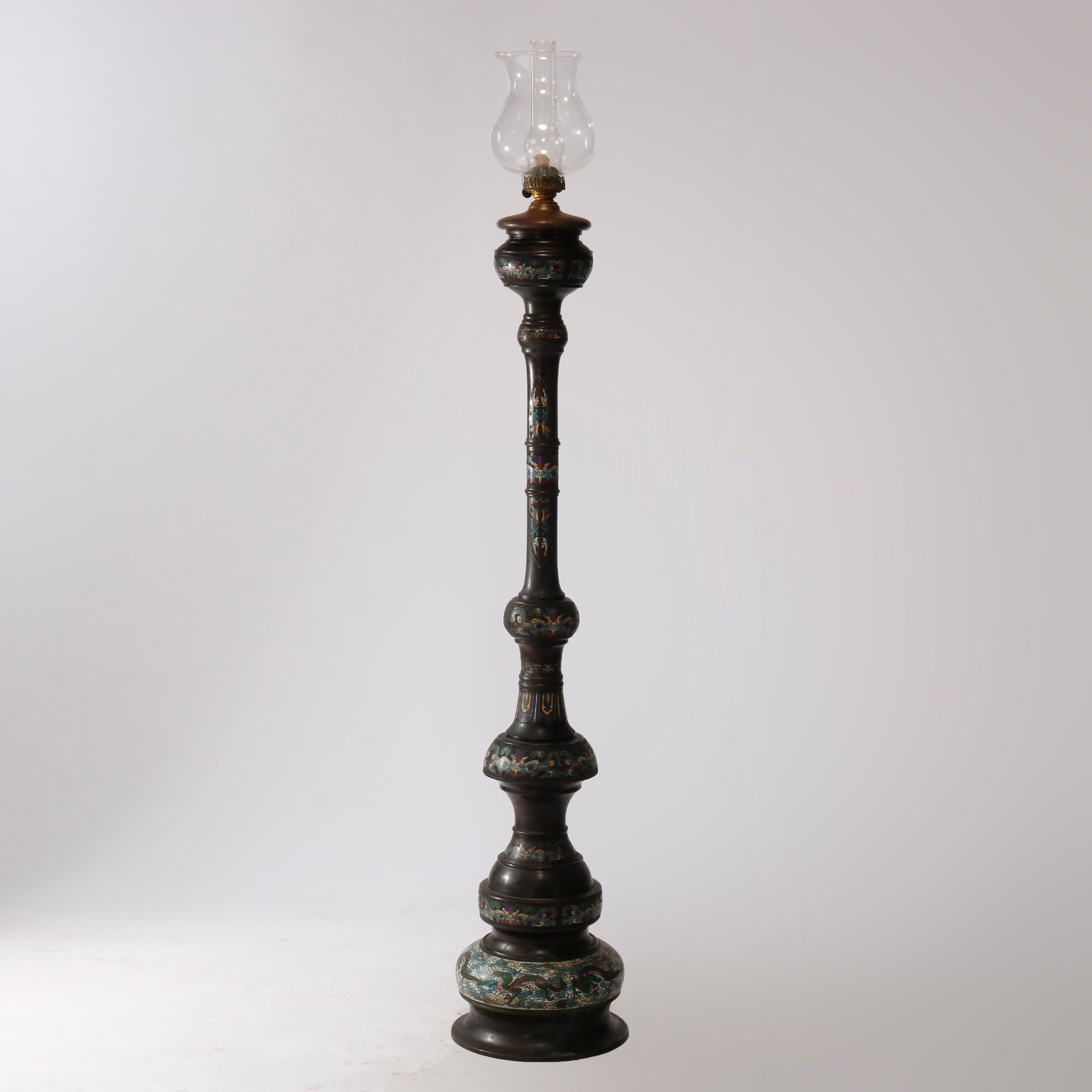 An antique and rare Chinese oil floor lamp offers bronze balustrade form construction with enameled champleve cloisonne dragon, cloud, floral and foliate motif, non-electric, c1890

Measures - 74''H x 13''W x 13''D.