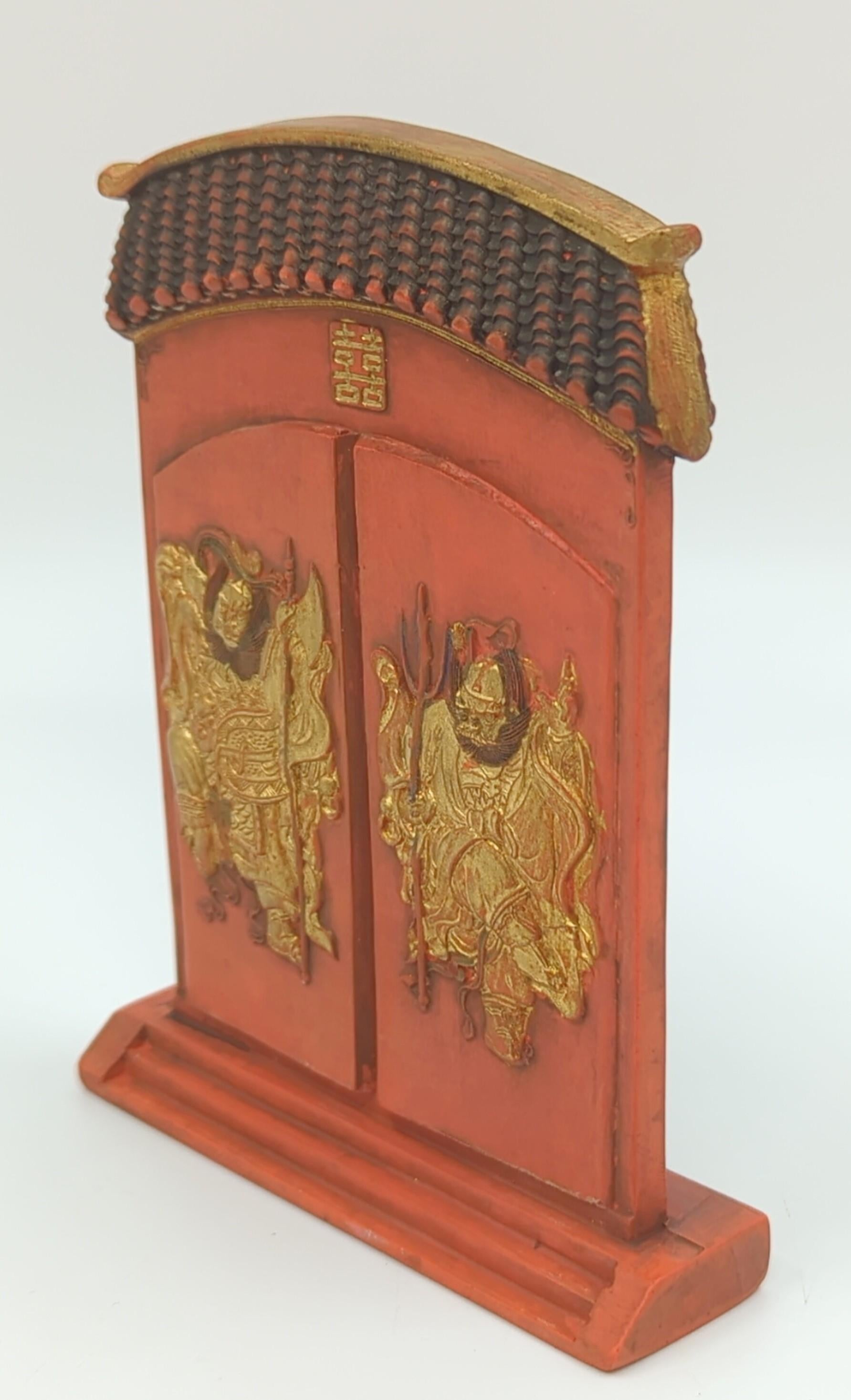 A rare antique Chinese Qing Dynasty Guangxu period Imperial style marked red ink stick, in the form of a roof tiled double door entrance way, with two fierce guardian dieties carved in detailed low relief, one on each door front, detailed in gilt
